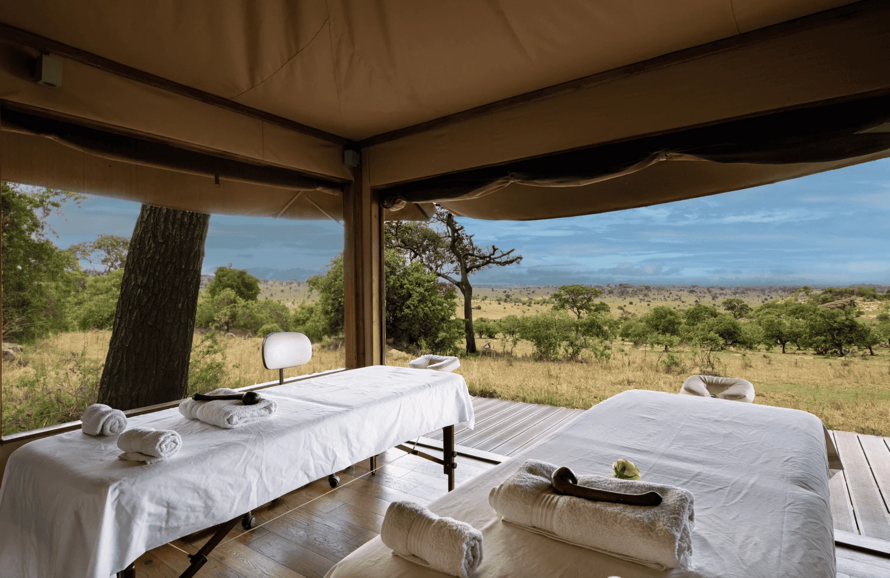 Massage beds set out under canvas with the plains beyond