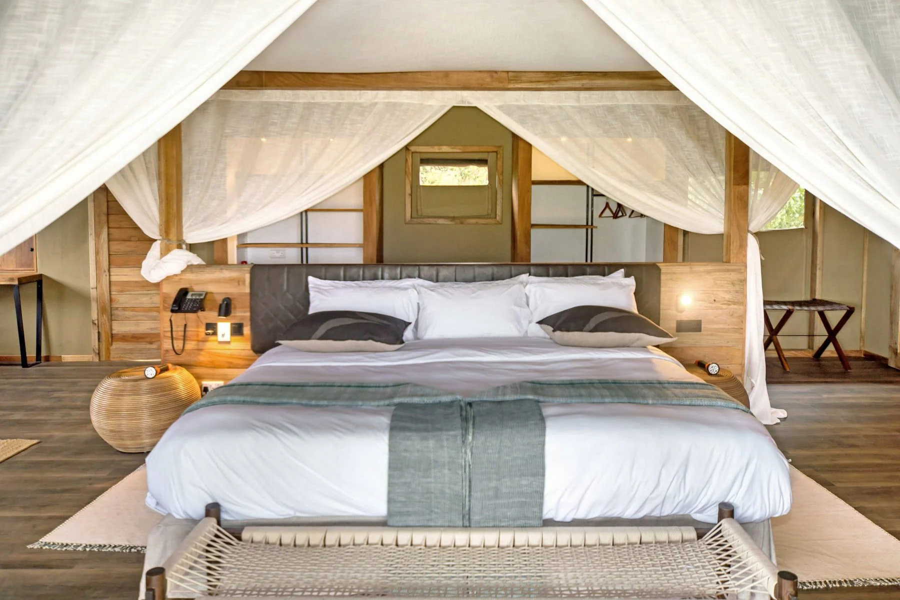 A bedroom with a draped four-poster bed