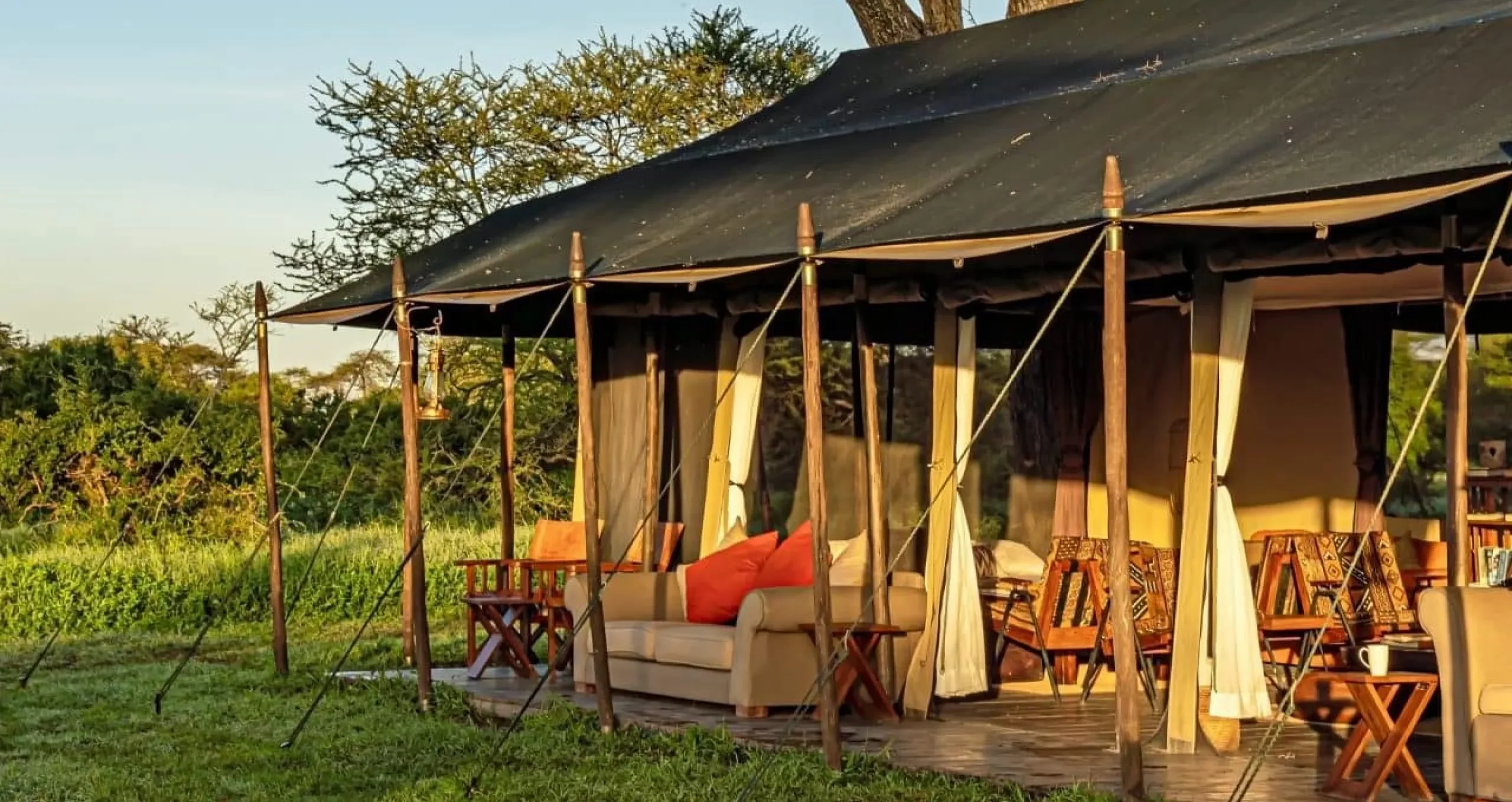 A guest tent with its awning raised at sunset