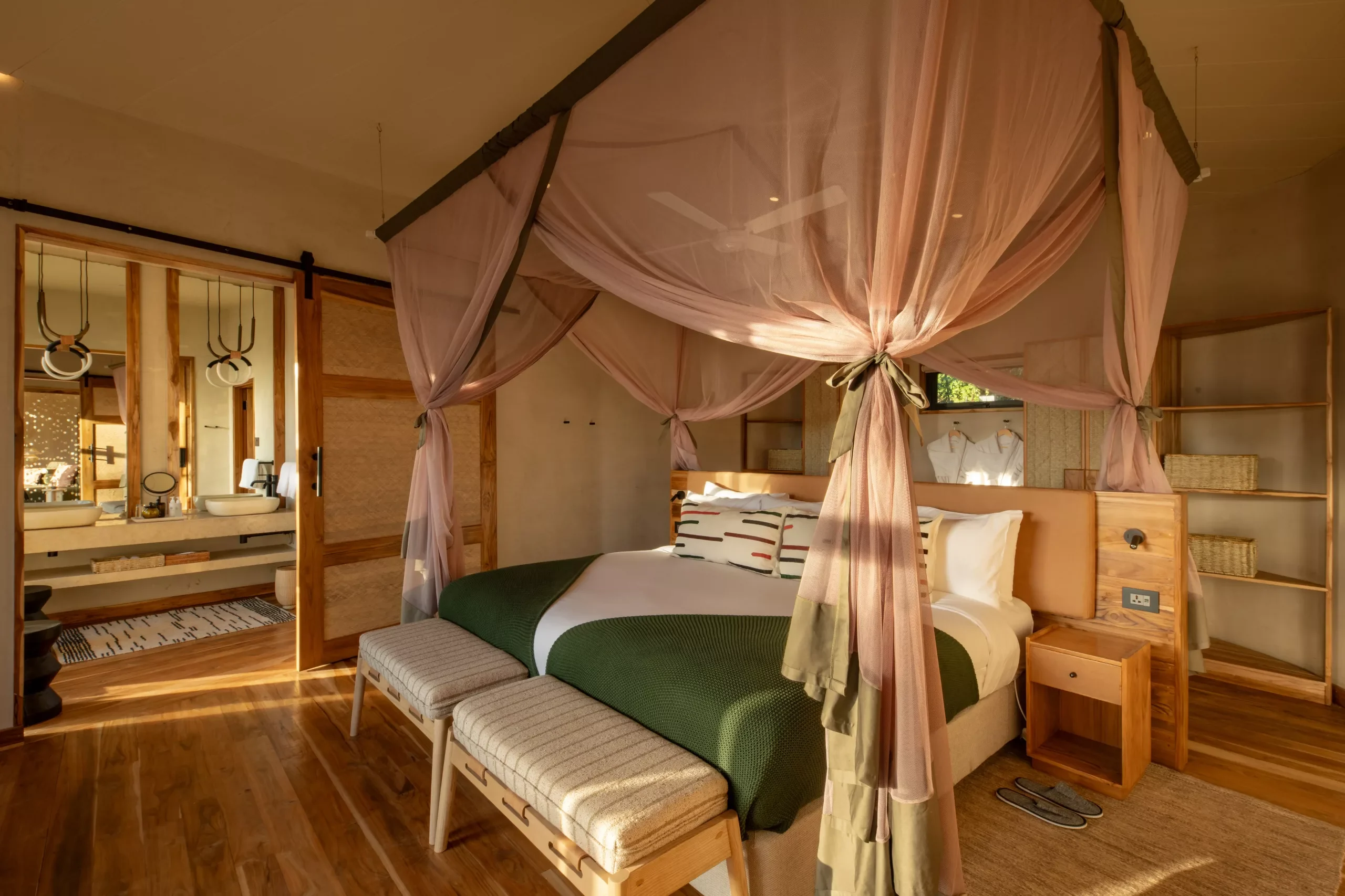 A bedroom with a draped four-poster bed