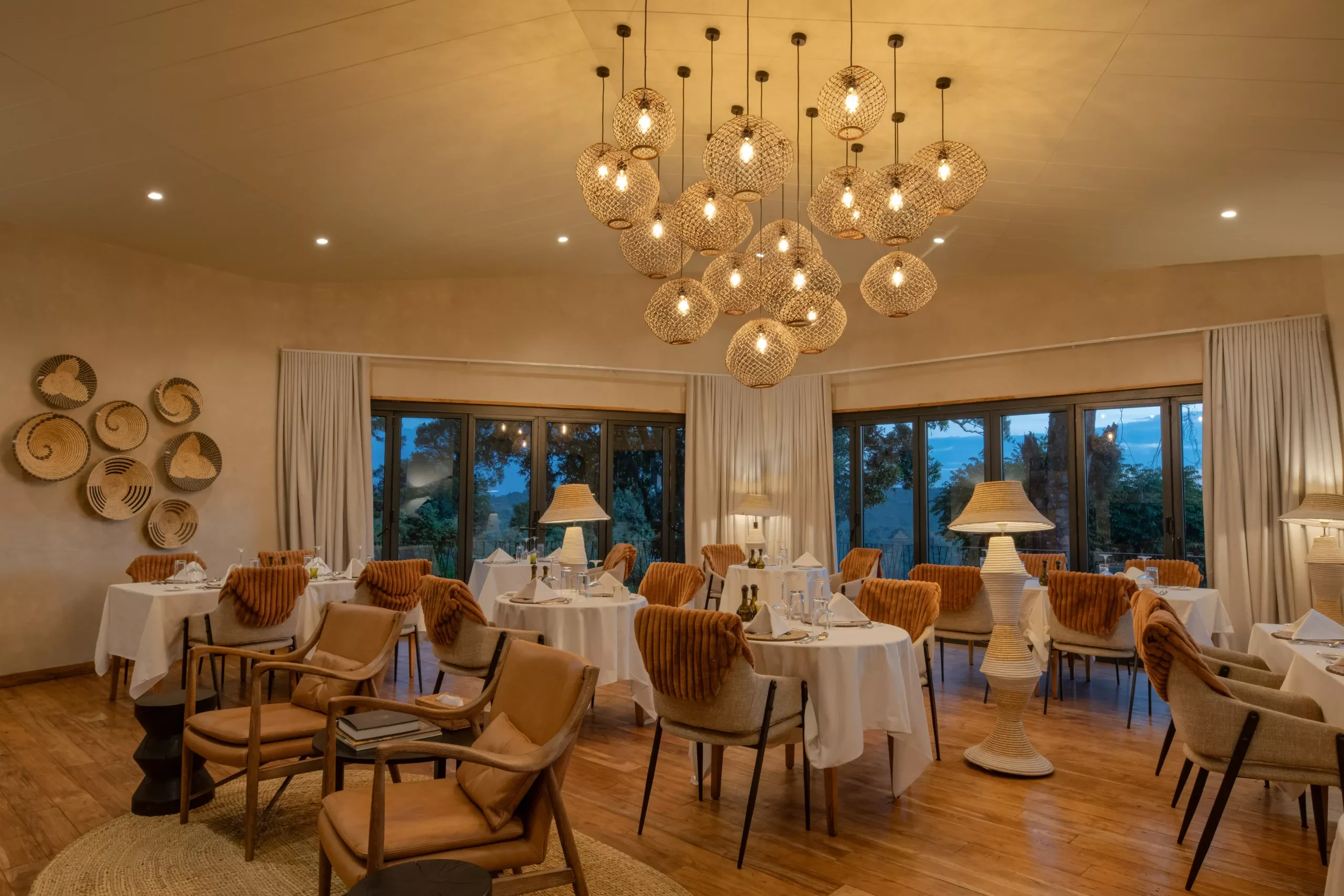 The dining room with pendant lamps and baskets on the wall