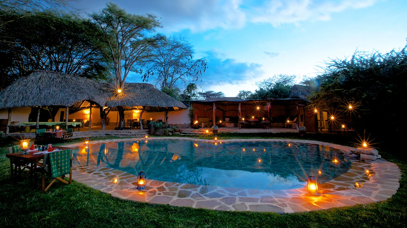 The pool and lounge lit at dusk