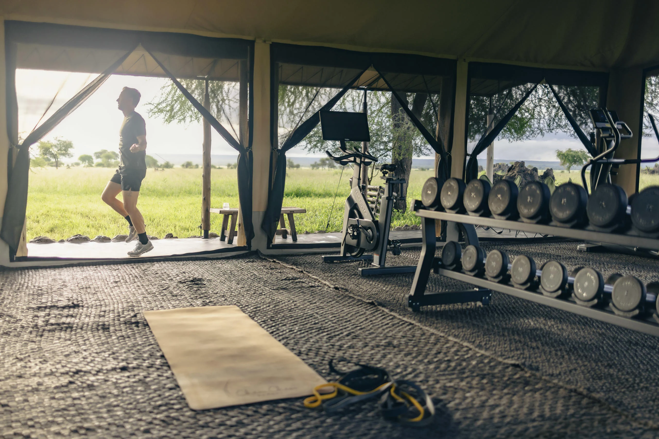 The gym tent with weights and a yoga mat
