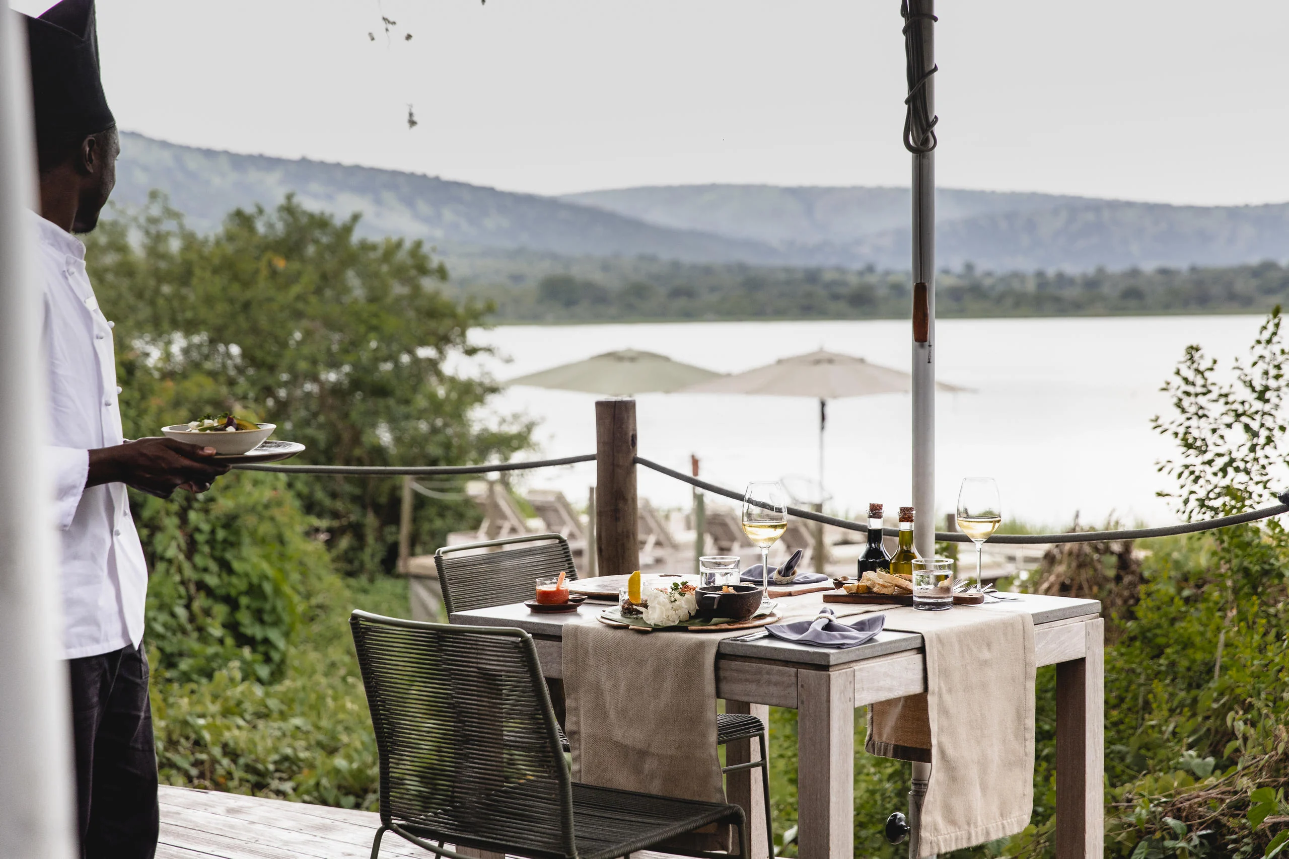 A table set on the deck above the lake