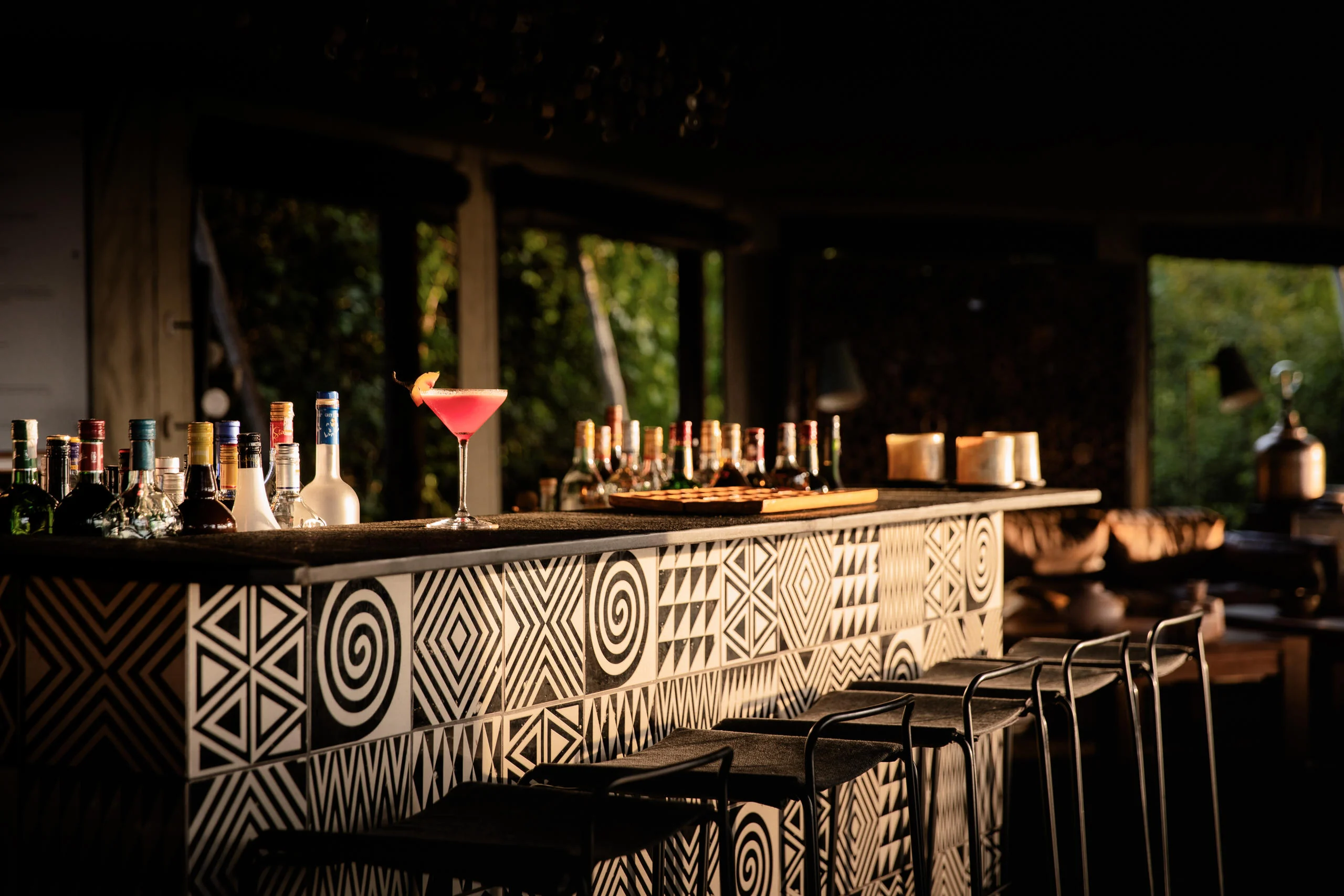 Bottles and a cocktail on the bar counter