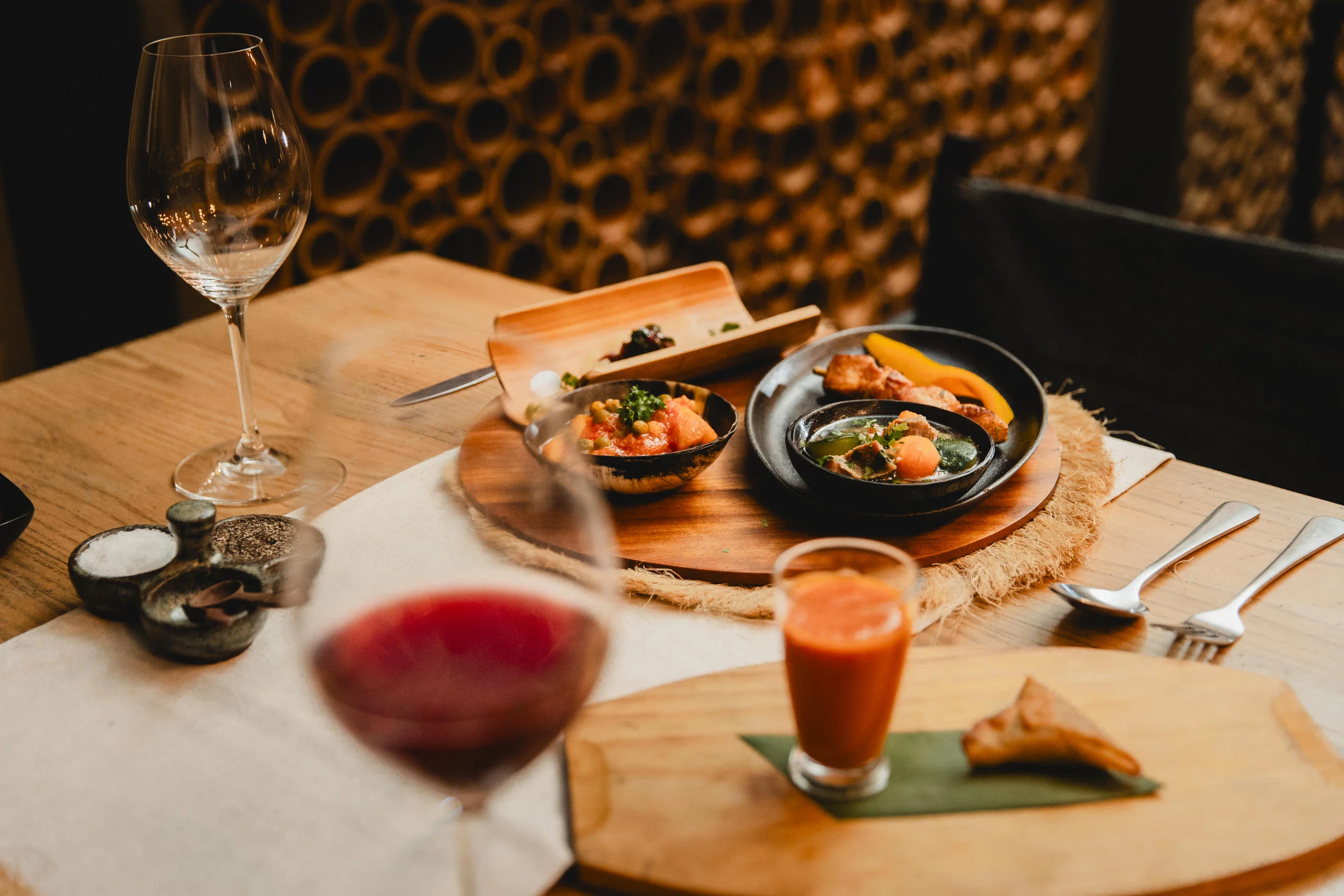 A dish and a glass of wine on a dining table