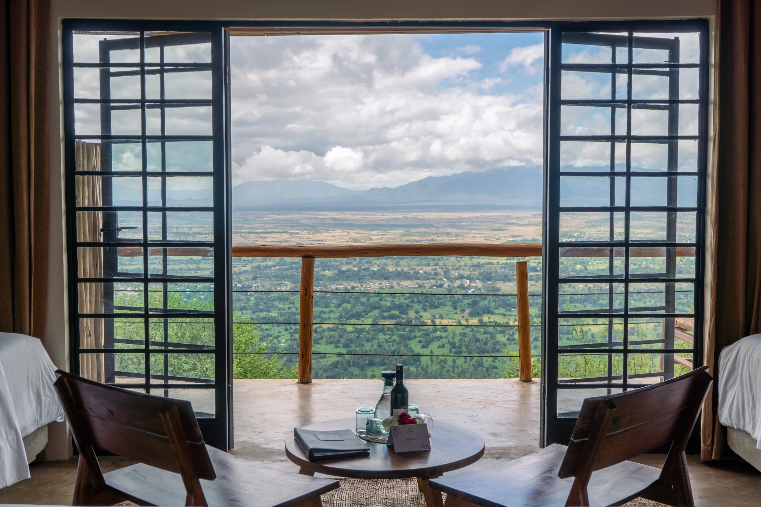 Doors opening from a room onto a balcony above the Rift Valley