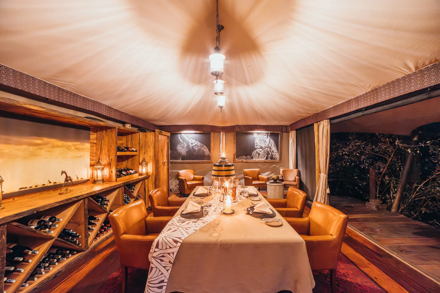 A dining table laid under the tent canopy