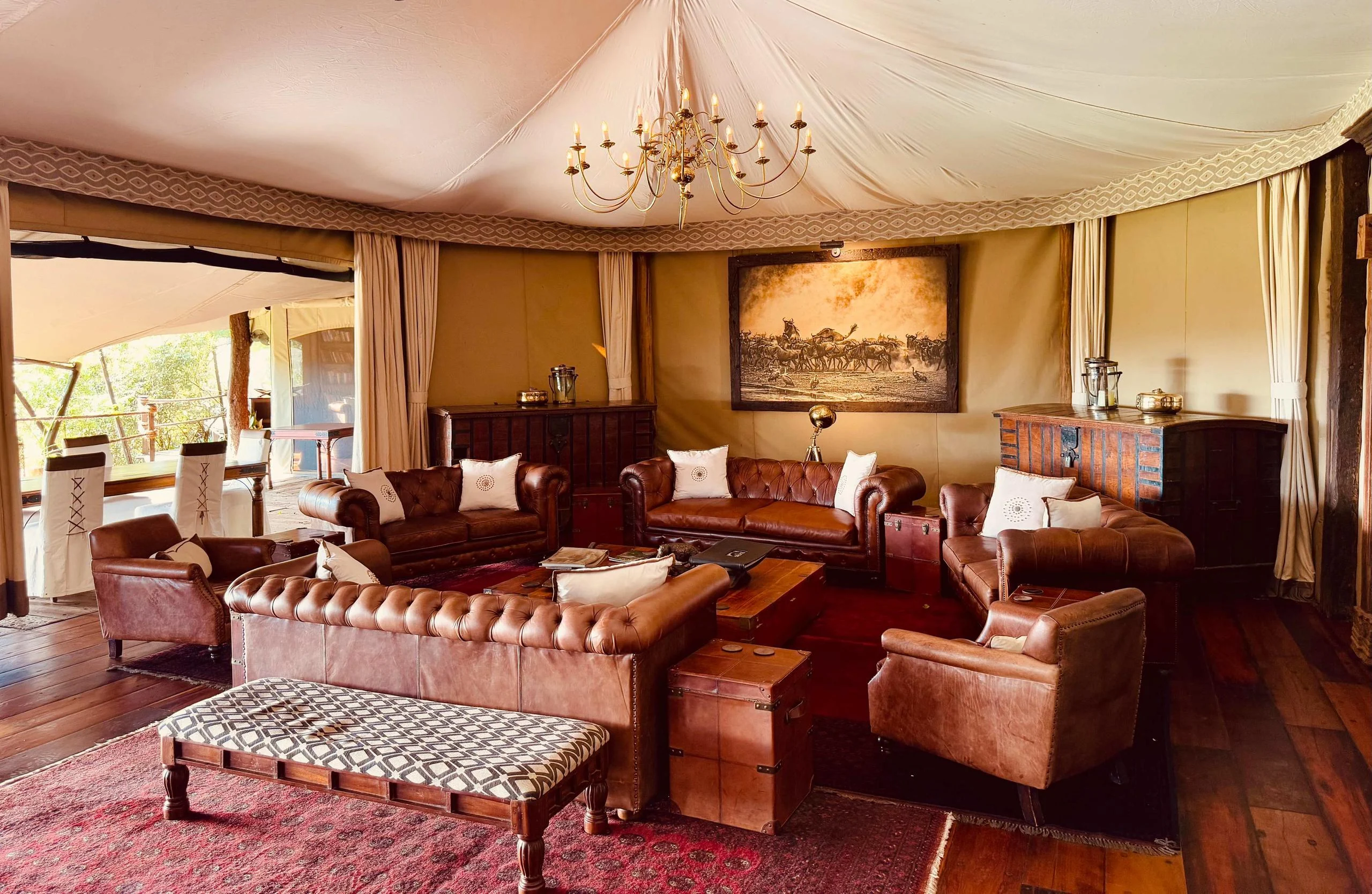 The lounge tent with leather sofas and a red rug