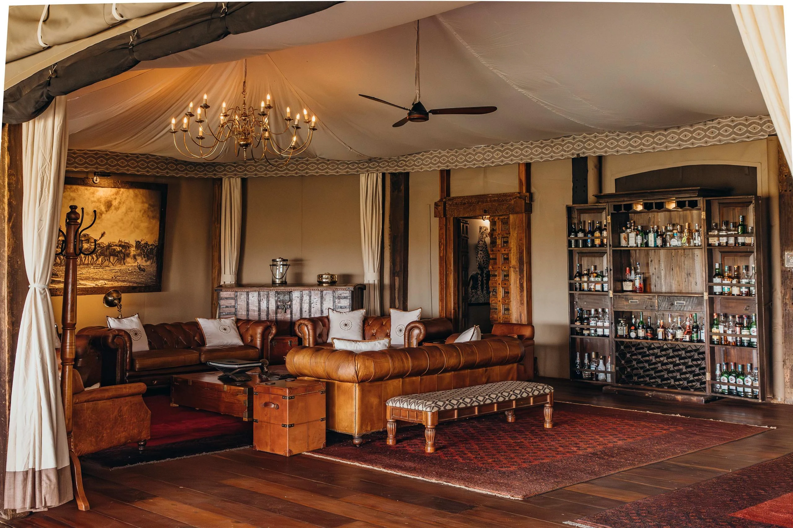The lounge tent with a chandelier and a bar