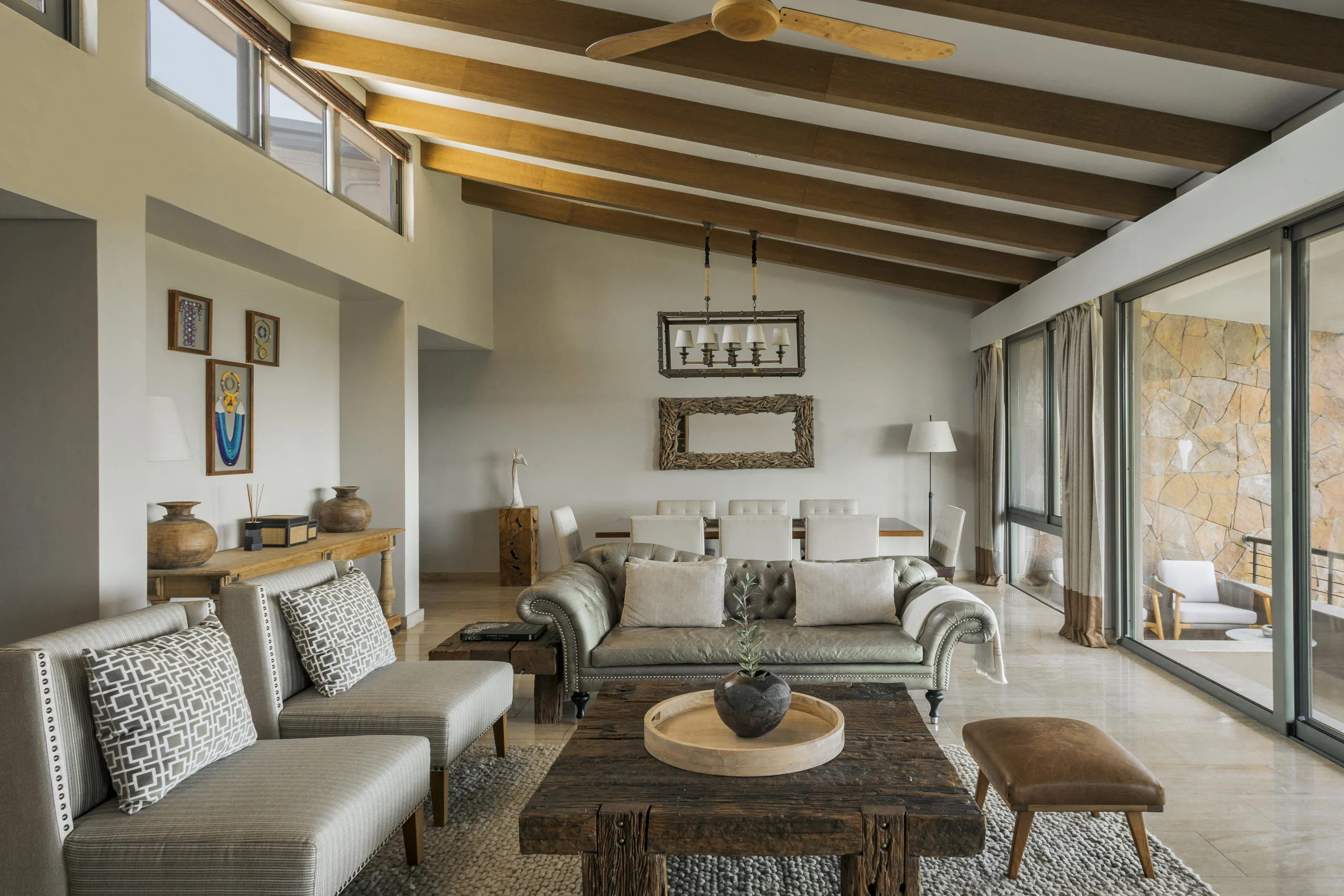 A suite sitting room with sofas and a timber ceiling