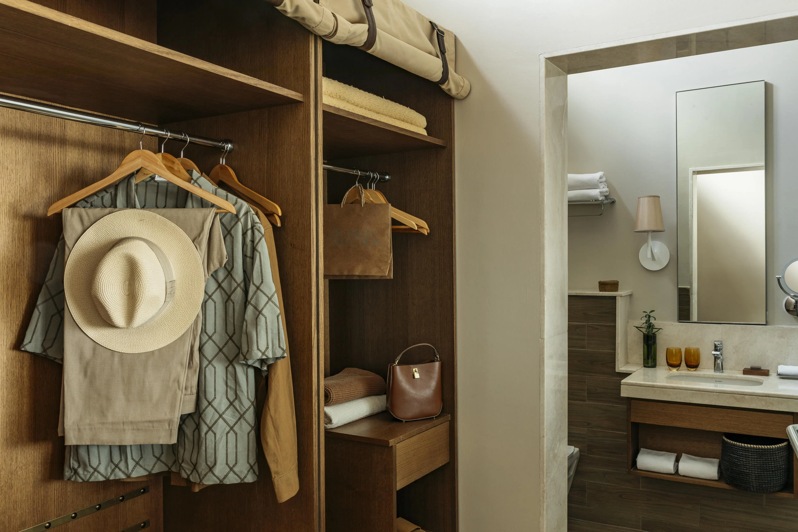 A dressing room with a hat and a jacket hanging