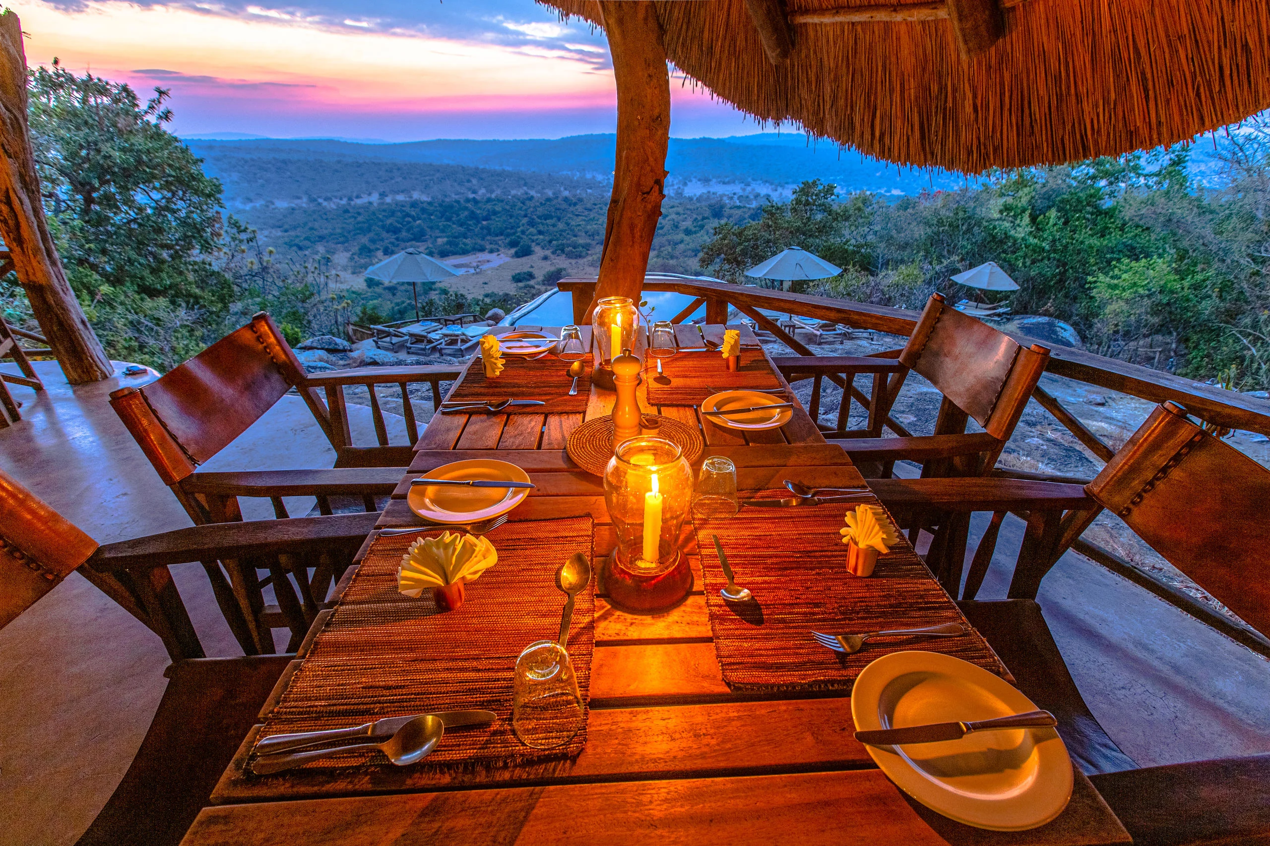 A table laid for dinner on the deck at sunset
