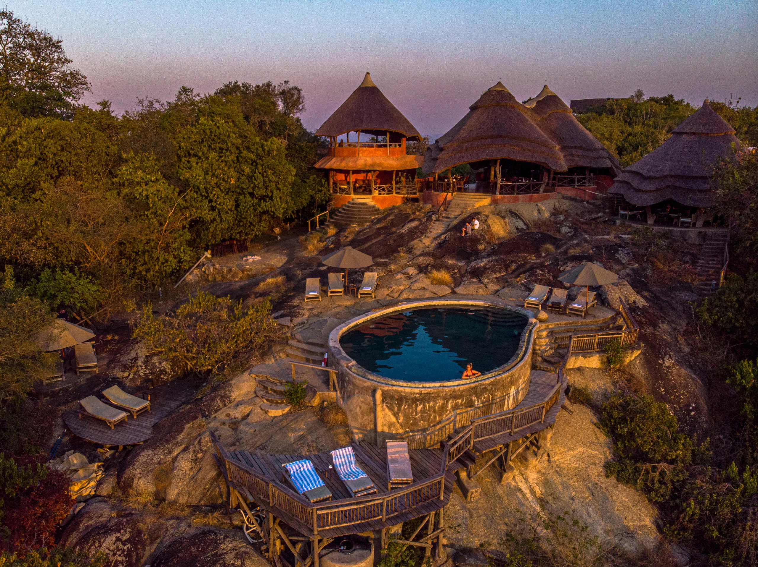 The pool and bandas on the rocky hilltop, from the air
