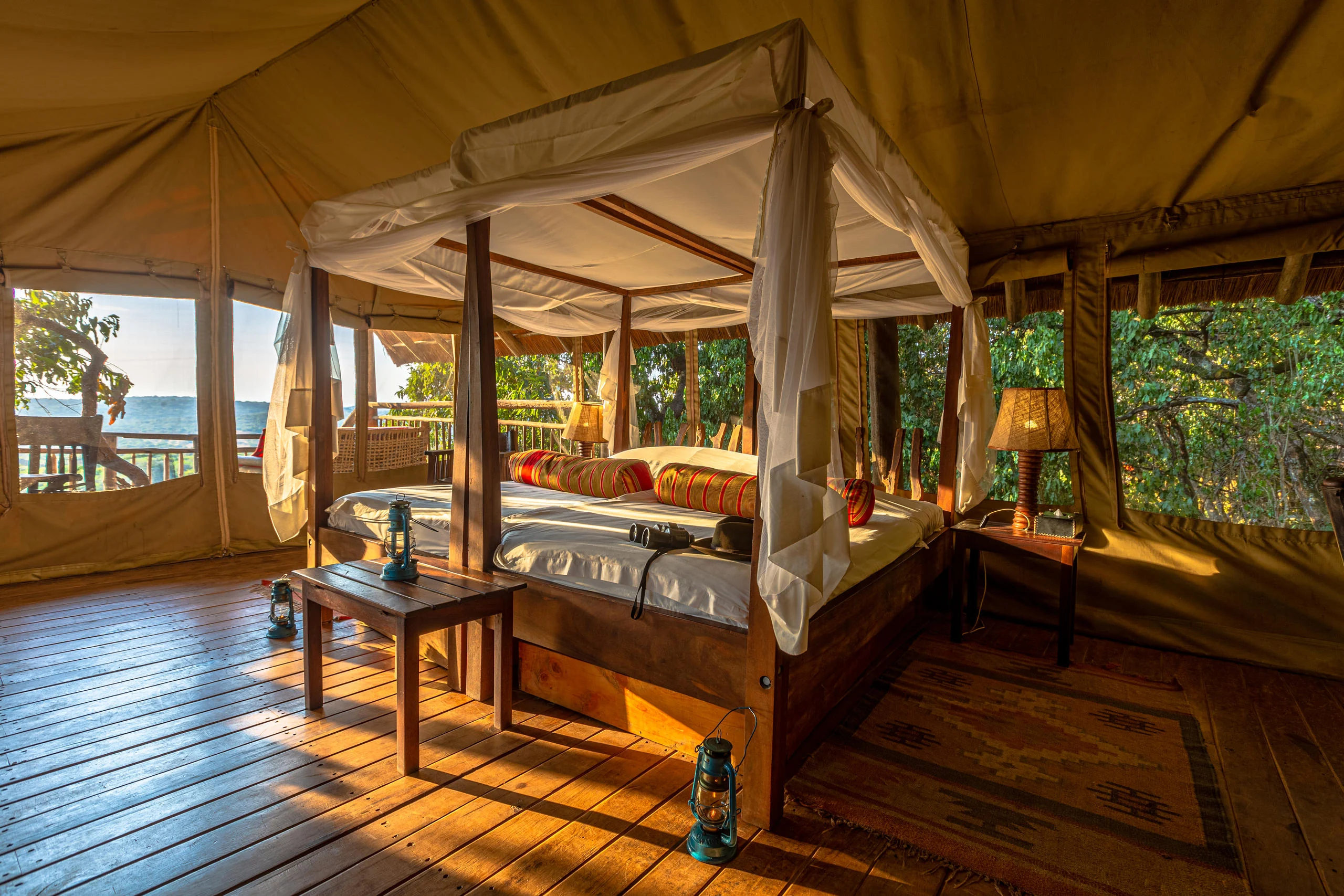 A tent bedroom with a canopied bed