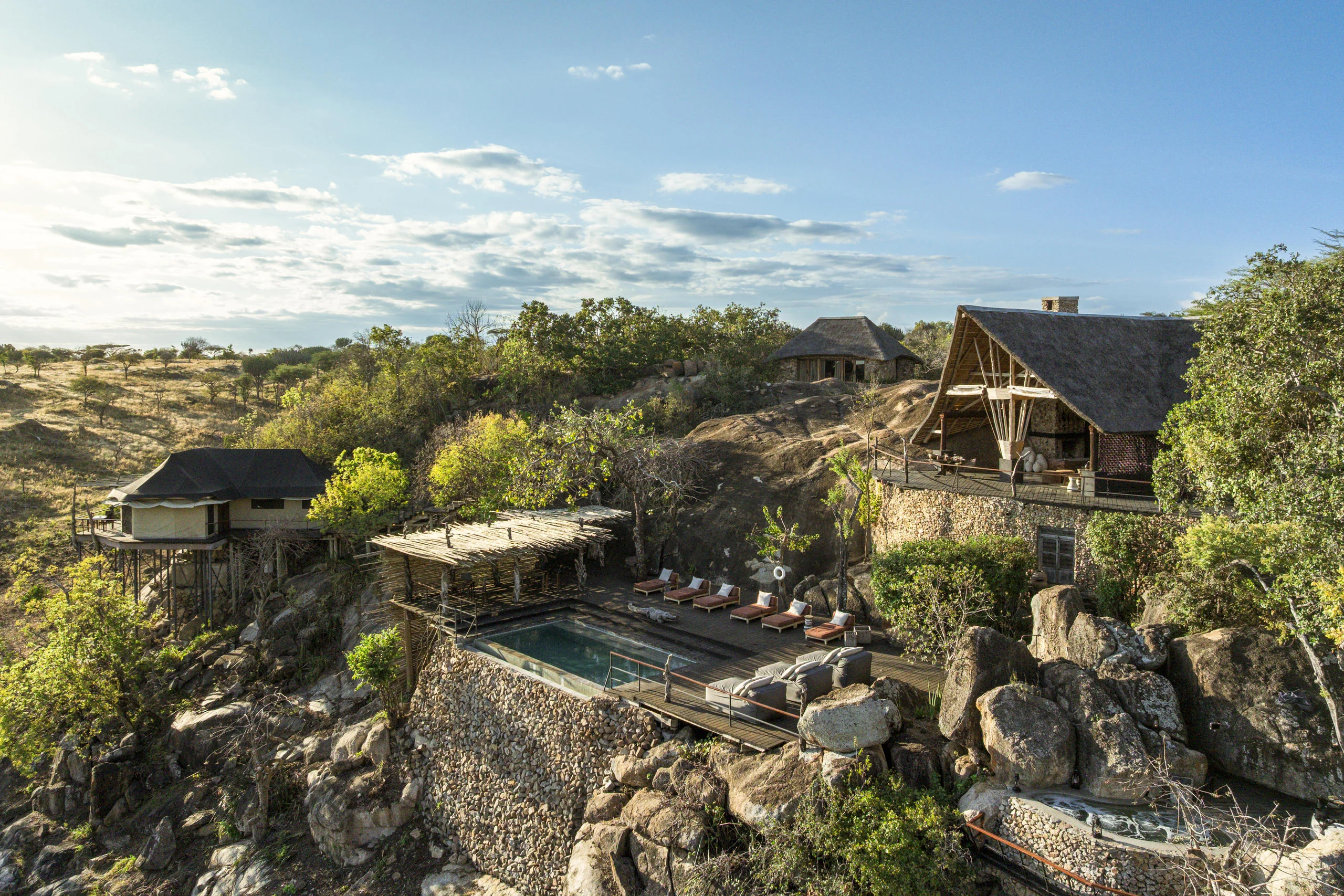 The lodge and its pool on the rocks, from the air