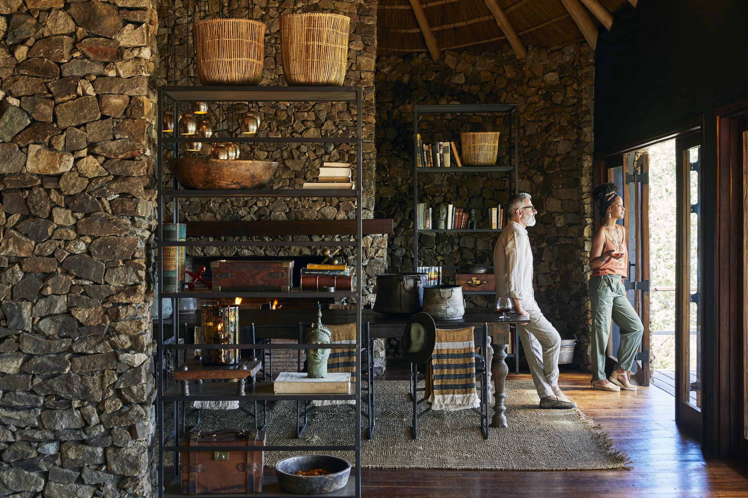 The lounge with stone walls and shelves