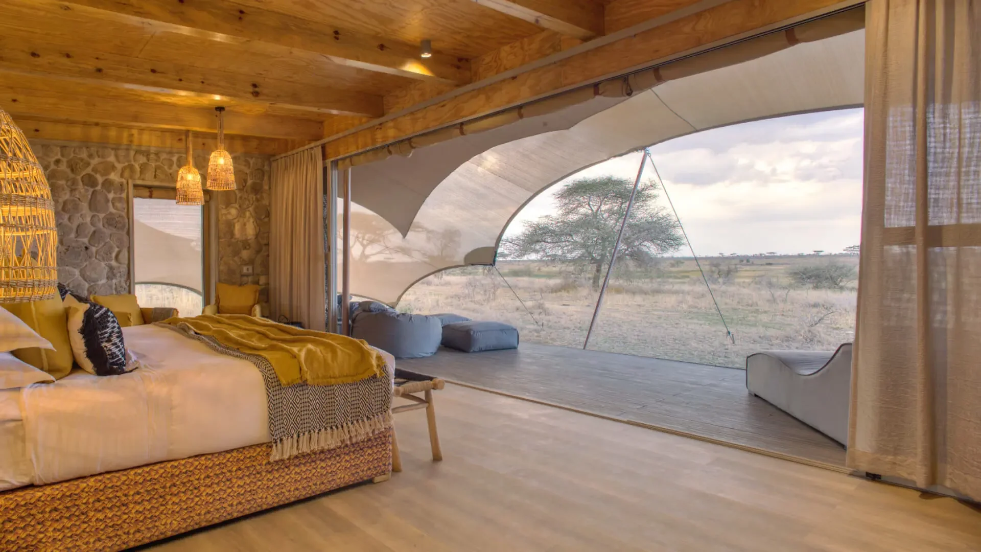 A tent bedroom with the front open to the plains