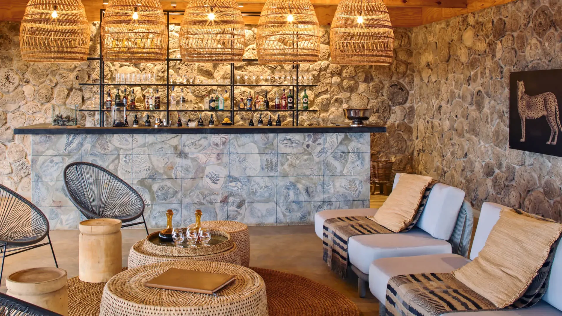 The bar with a stone wall and woven chairs