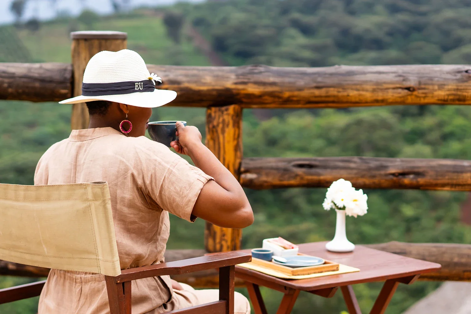 A guest with a cup of coffee on a balcony