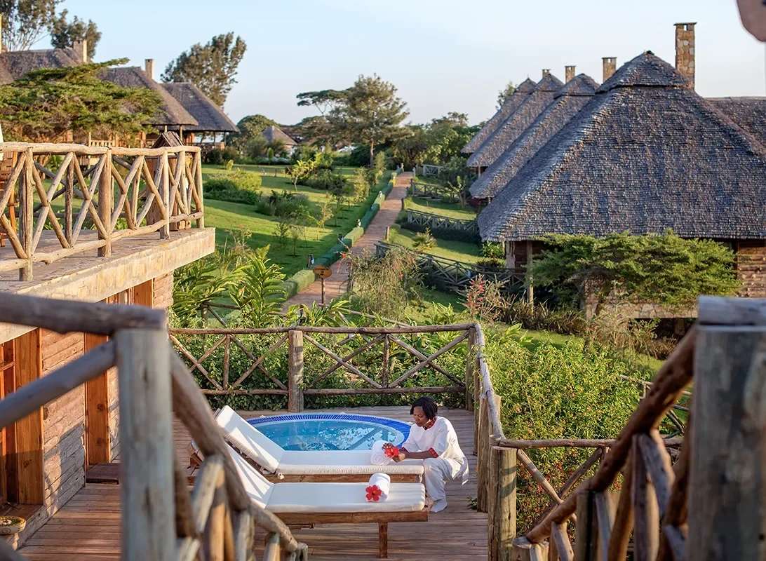 A guest in a hot tub on a cottage balcony