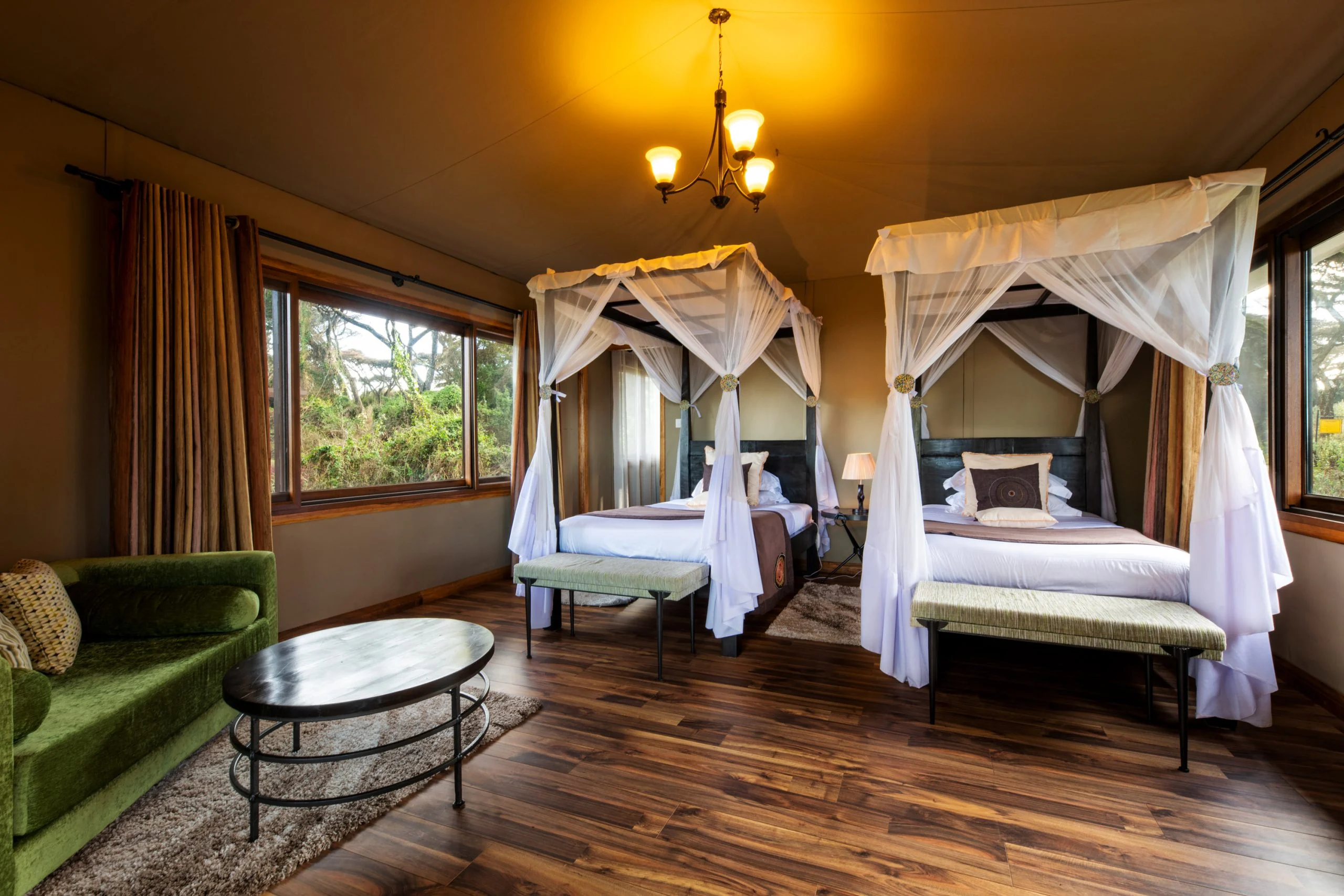 A bedroom with twin draped beds
