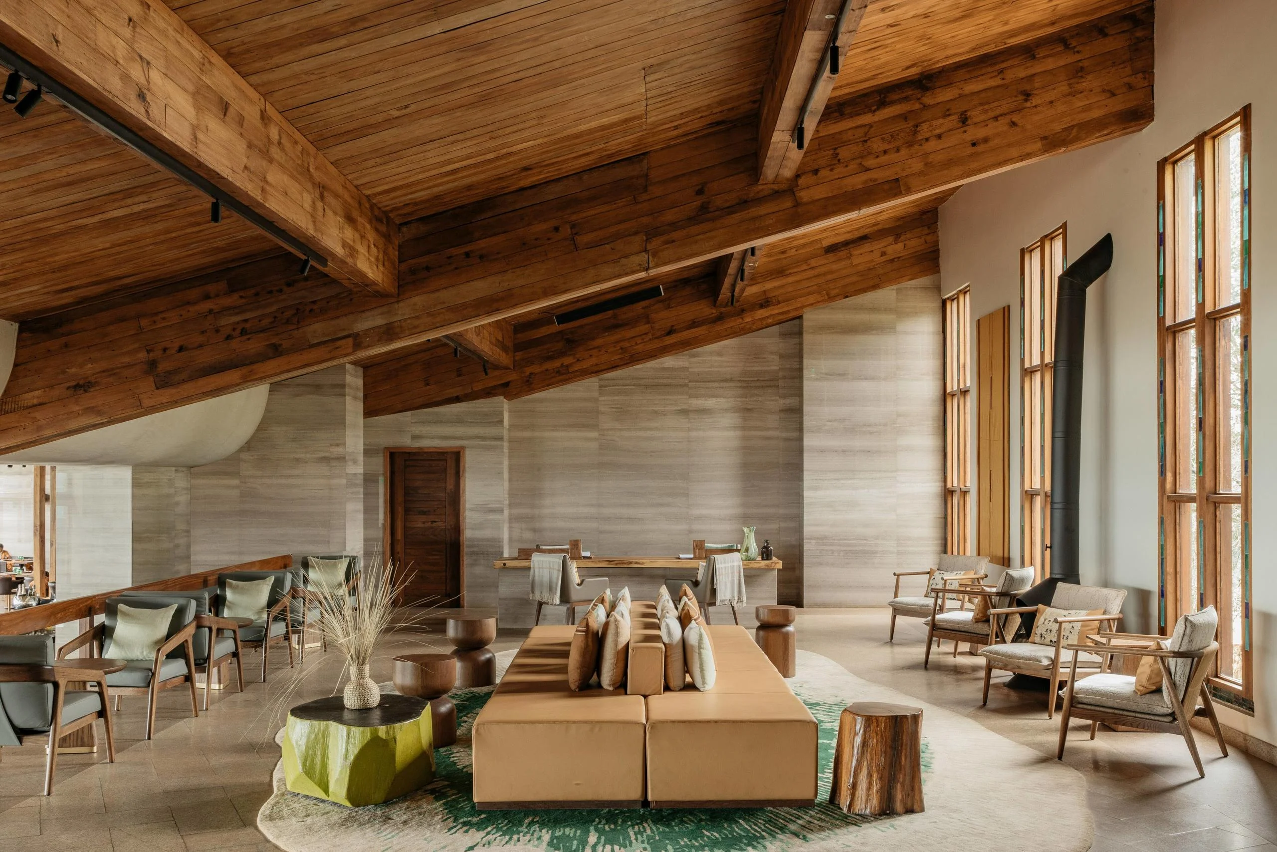 The lounge with timber ceilings and armchairs
