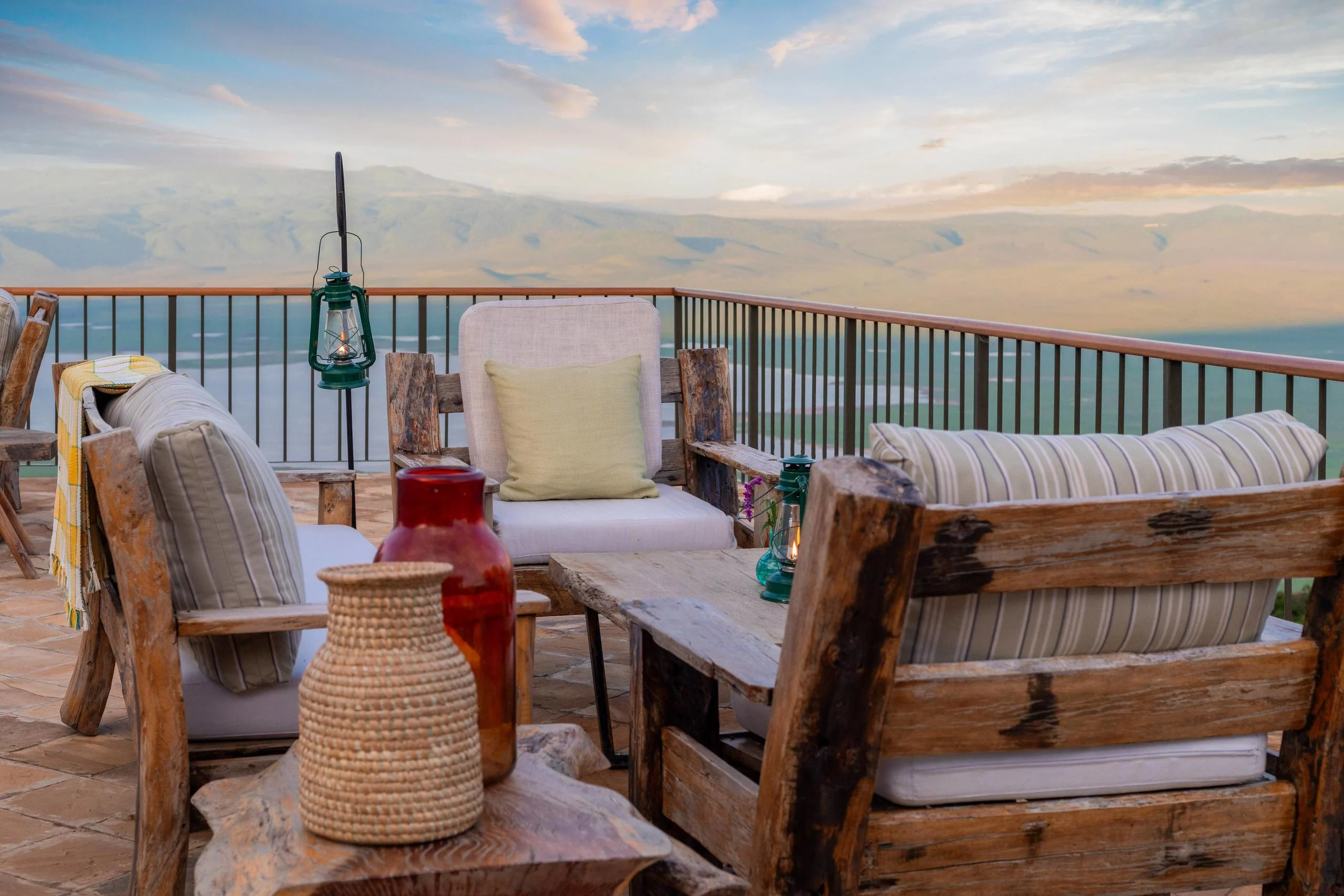 Chairs on the terrace at dusk with a lantern