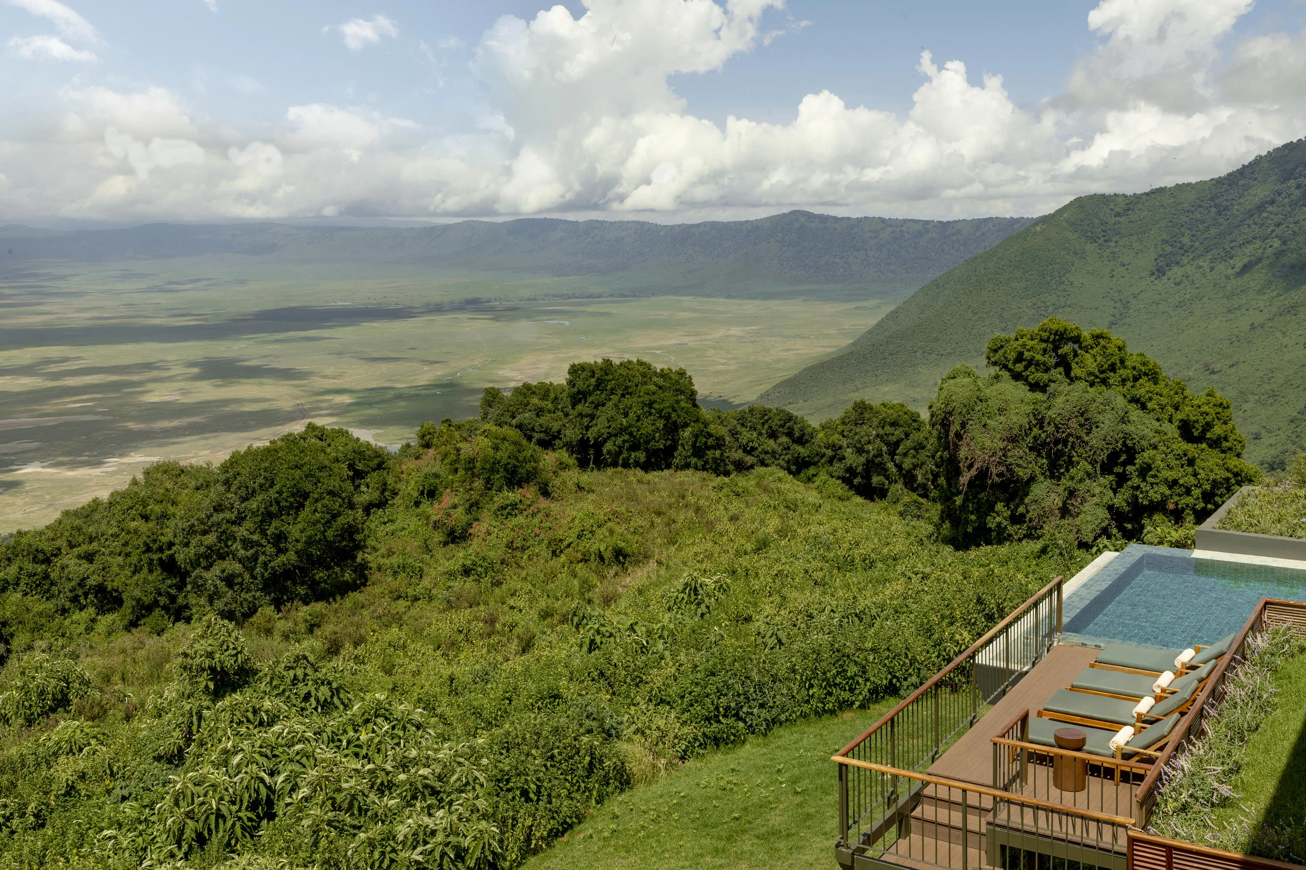 The lodge and pool on the forested crater rim
