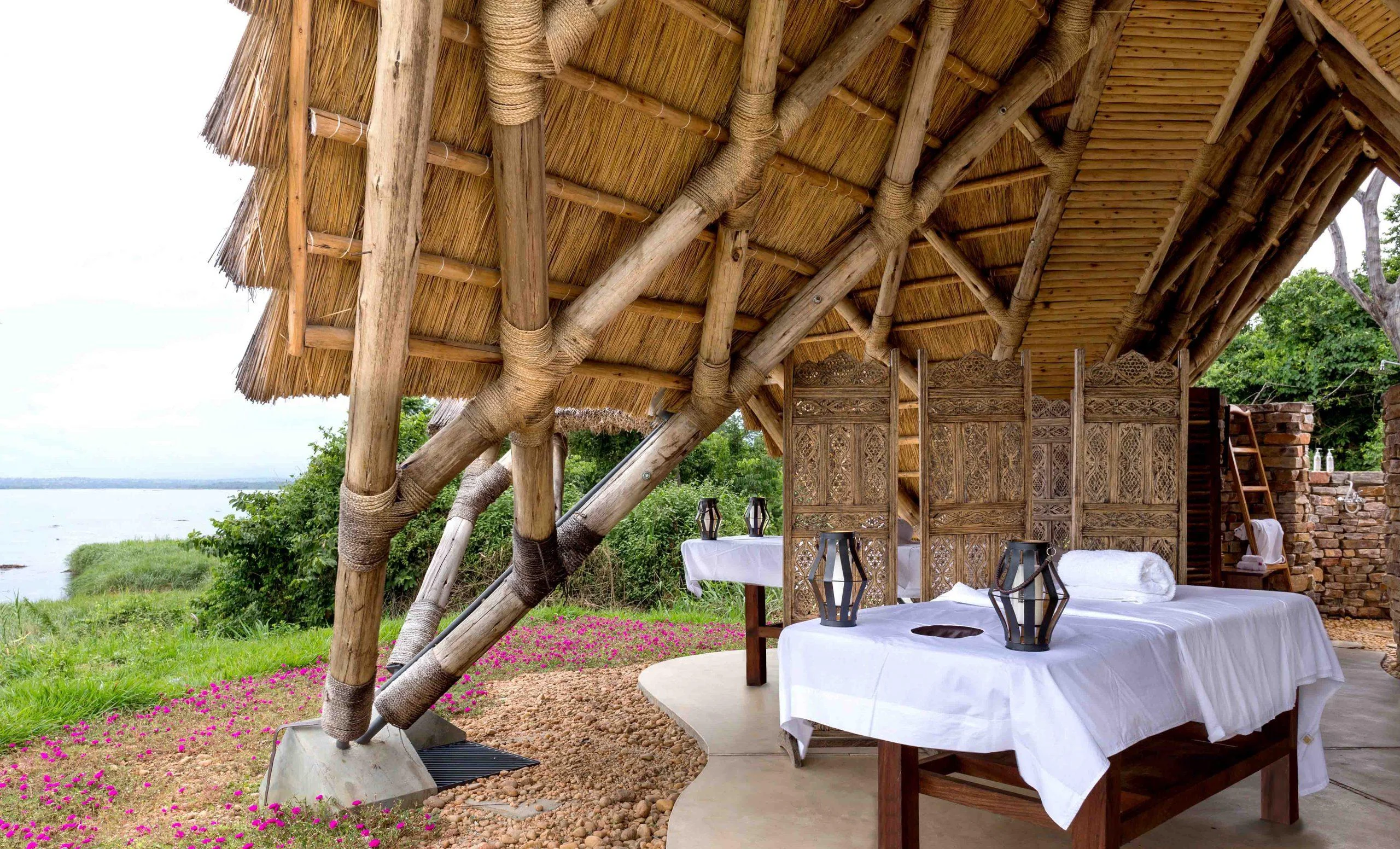 A table laid under the timber roof above the Nile