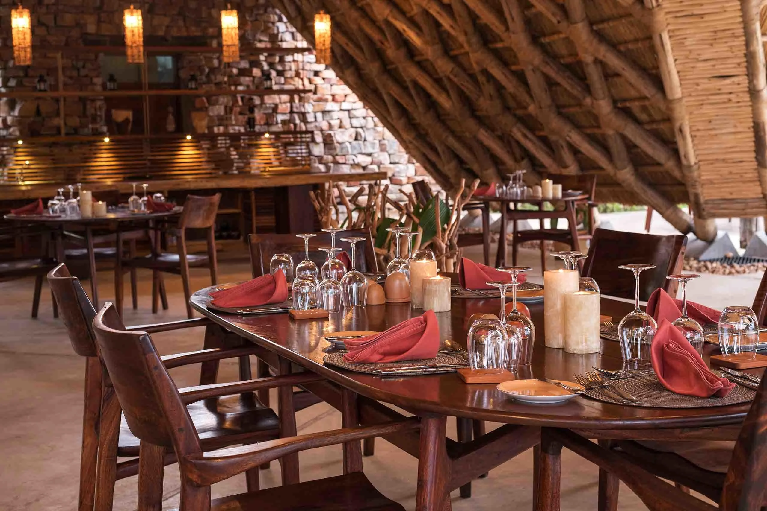 The dining room with tables laid under thatch
