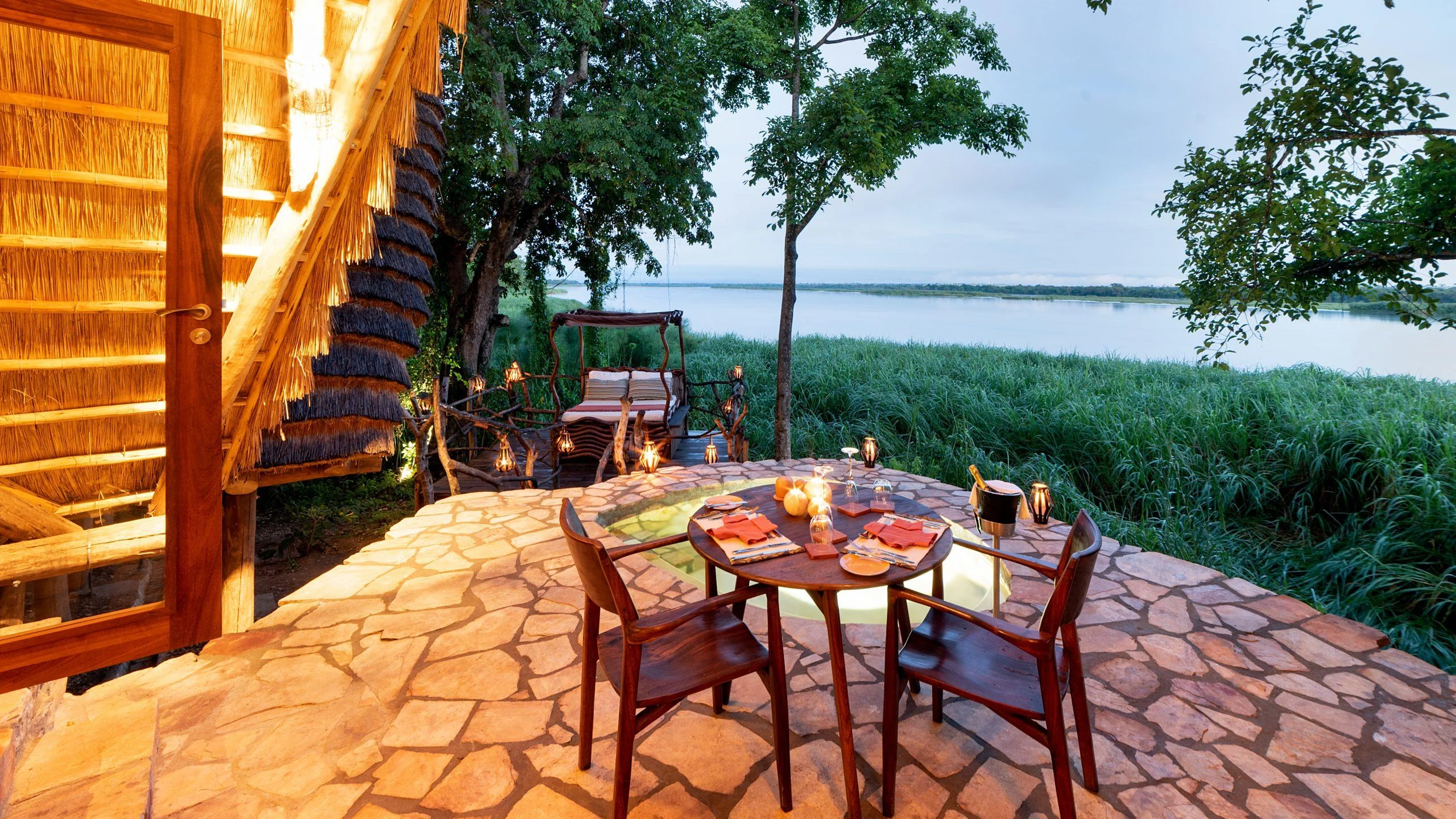 A table on a stone terrace above the river