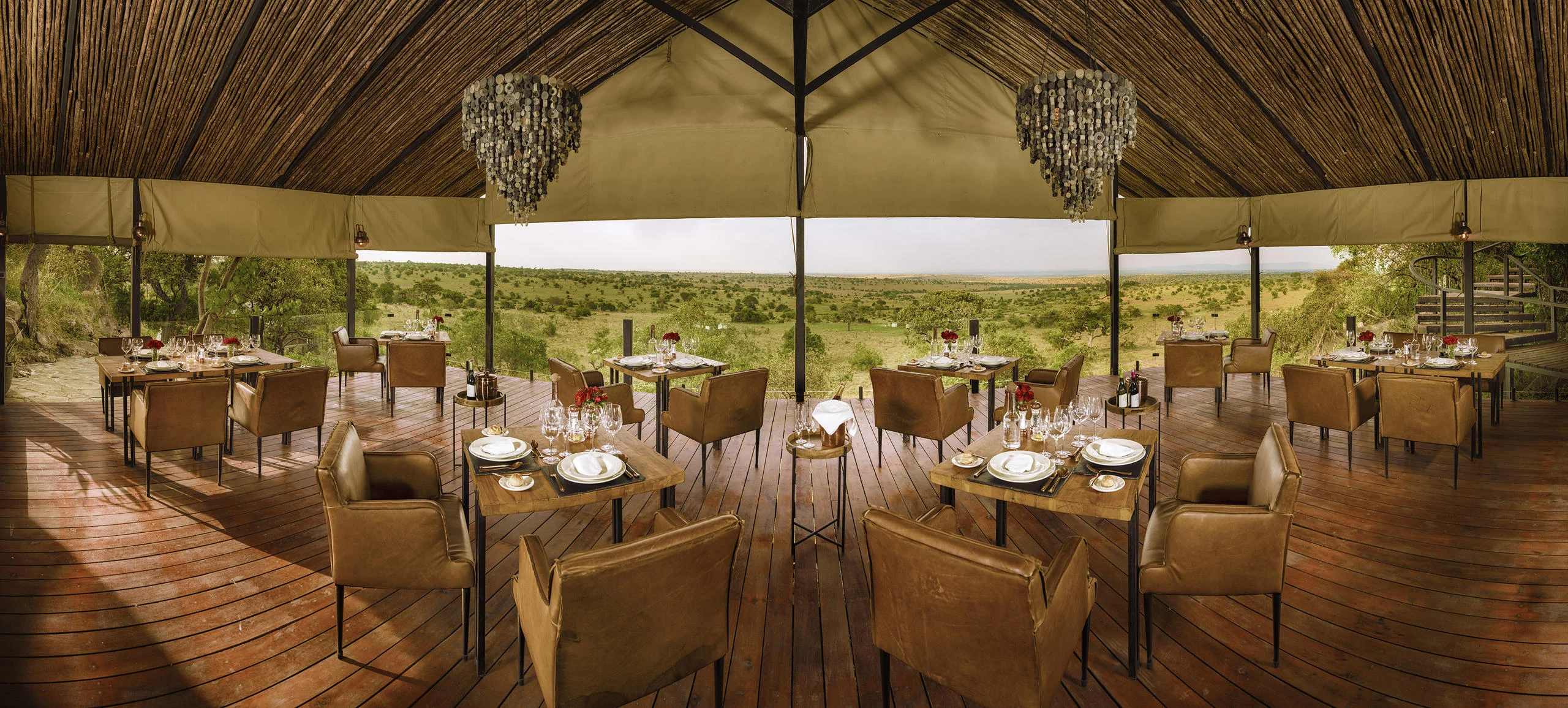 The dining room with tables laid, open to the plains