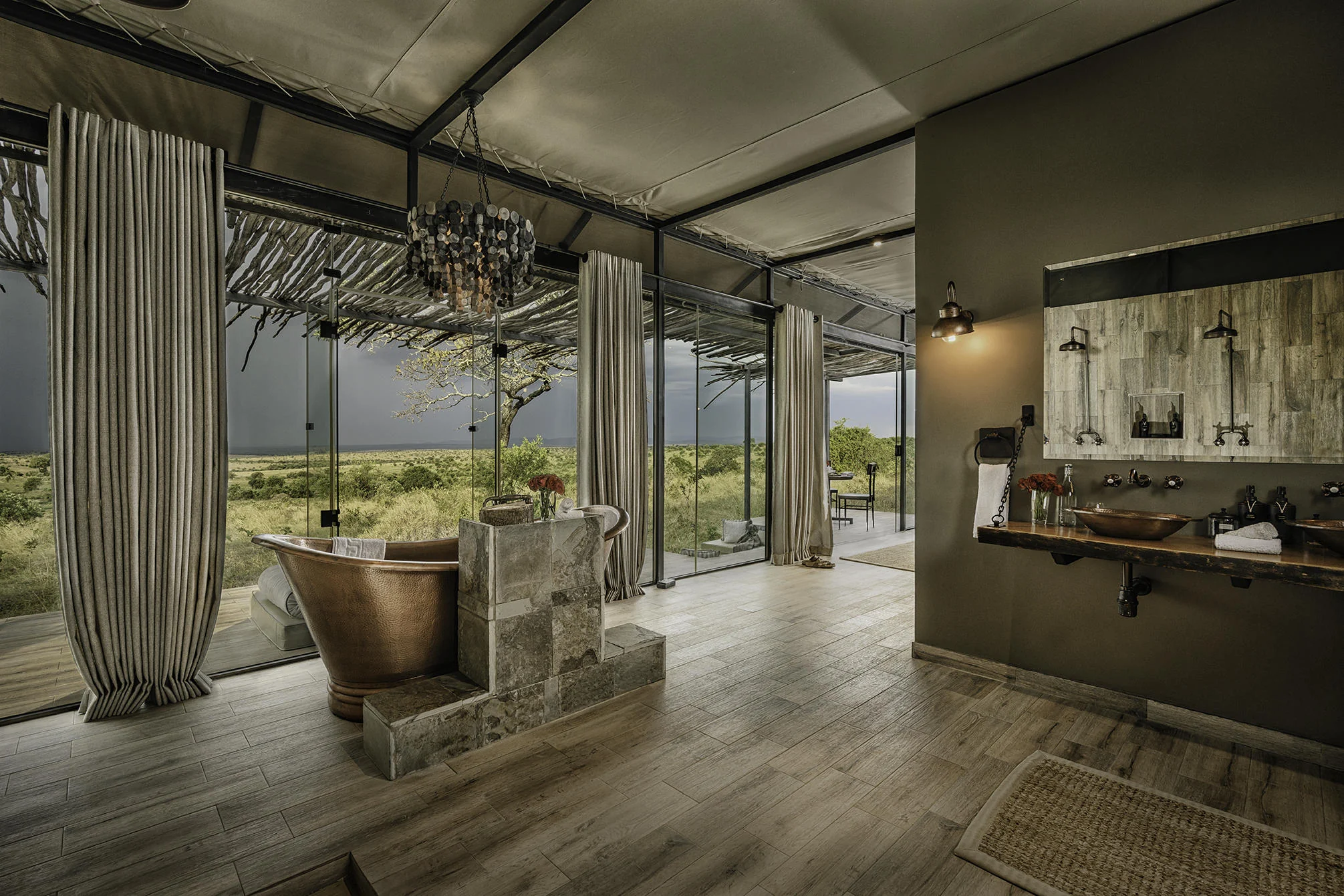 A bathroom with a copper bath and the plains beyond