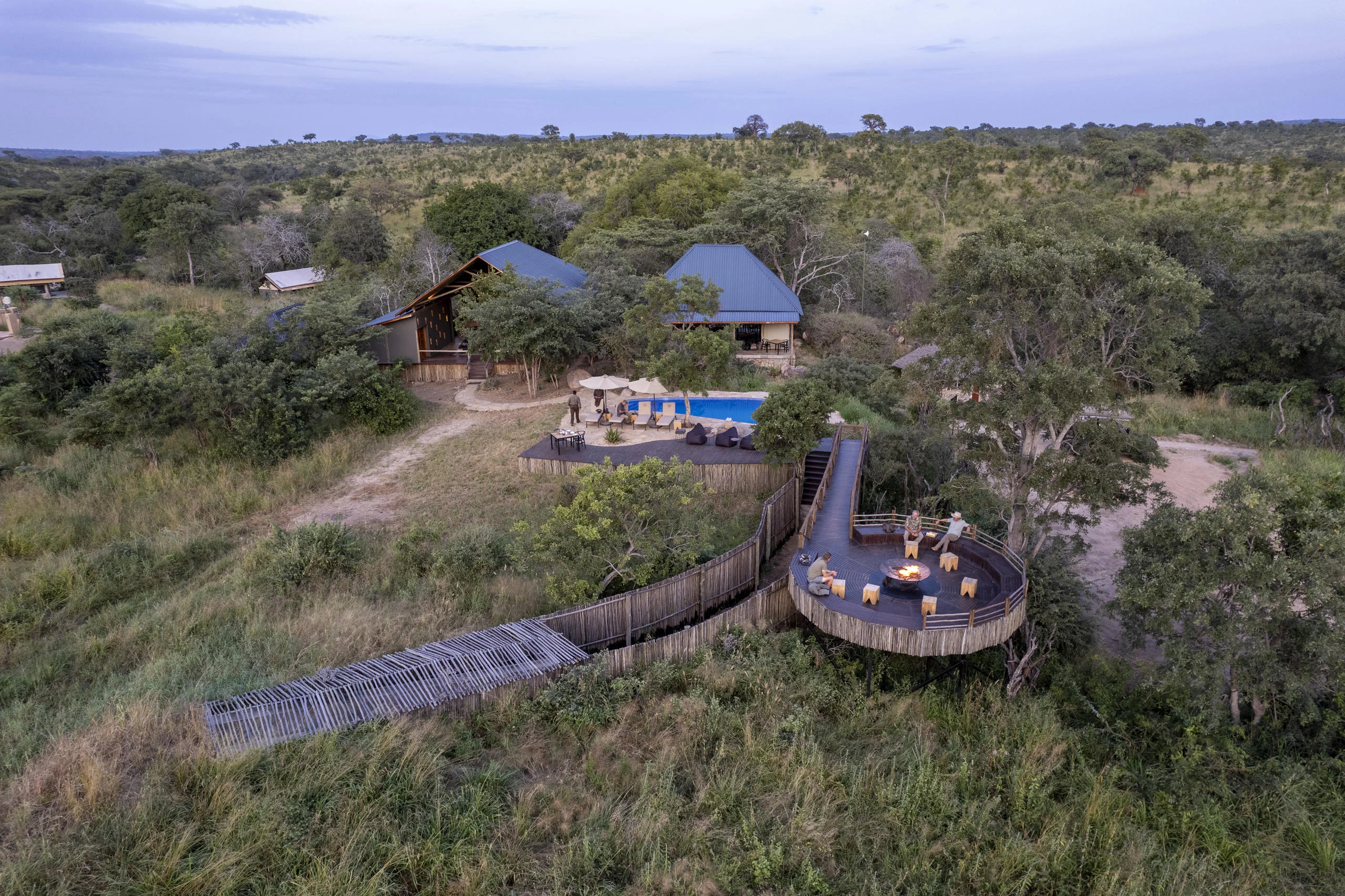 The camp's tents and pool among the trees, from the air