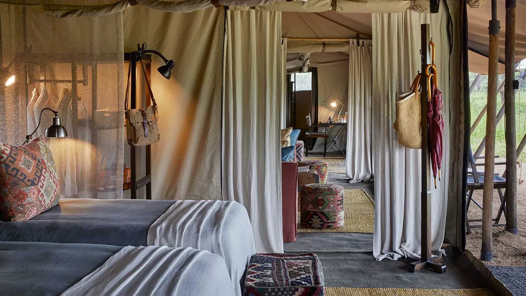 A tent with twin beds and drapes