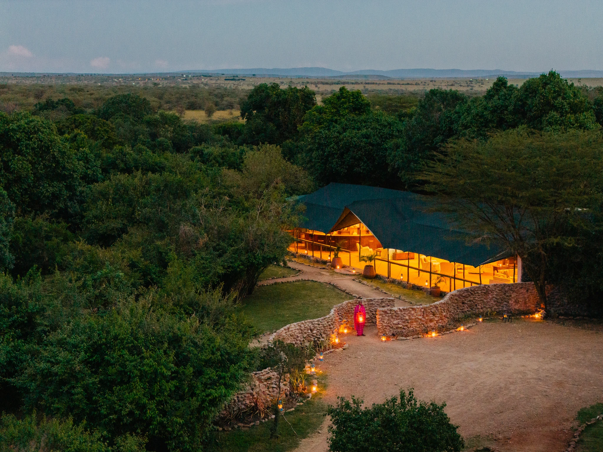 The camp lit at dusk, from the air