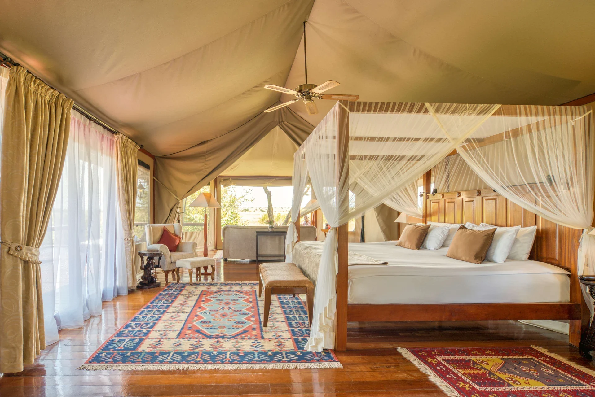 A tent bedroom with a four-poster bed