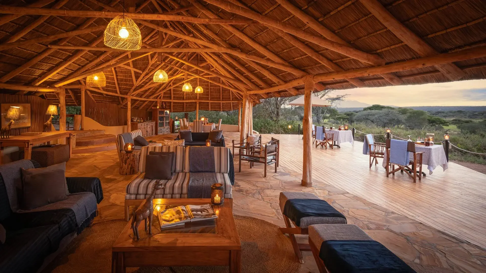 The lounge and dining area under thatch at dusk