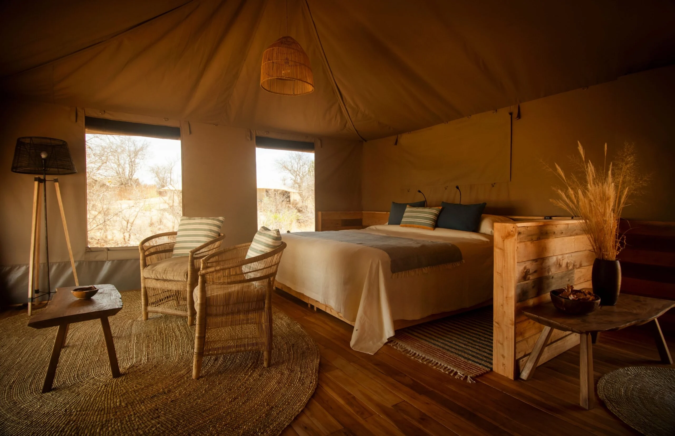 A tent bedroom with a window onto the woodland