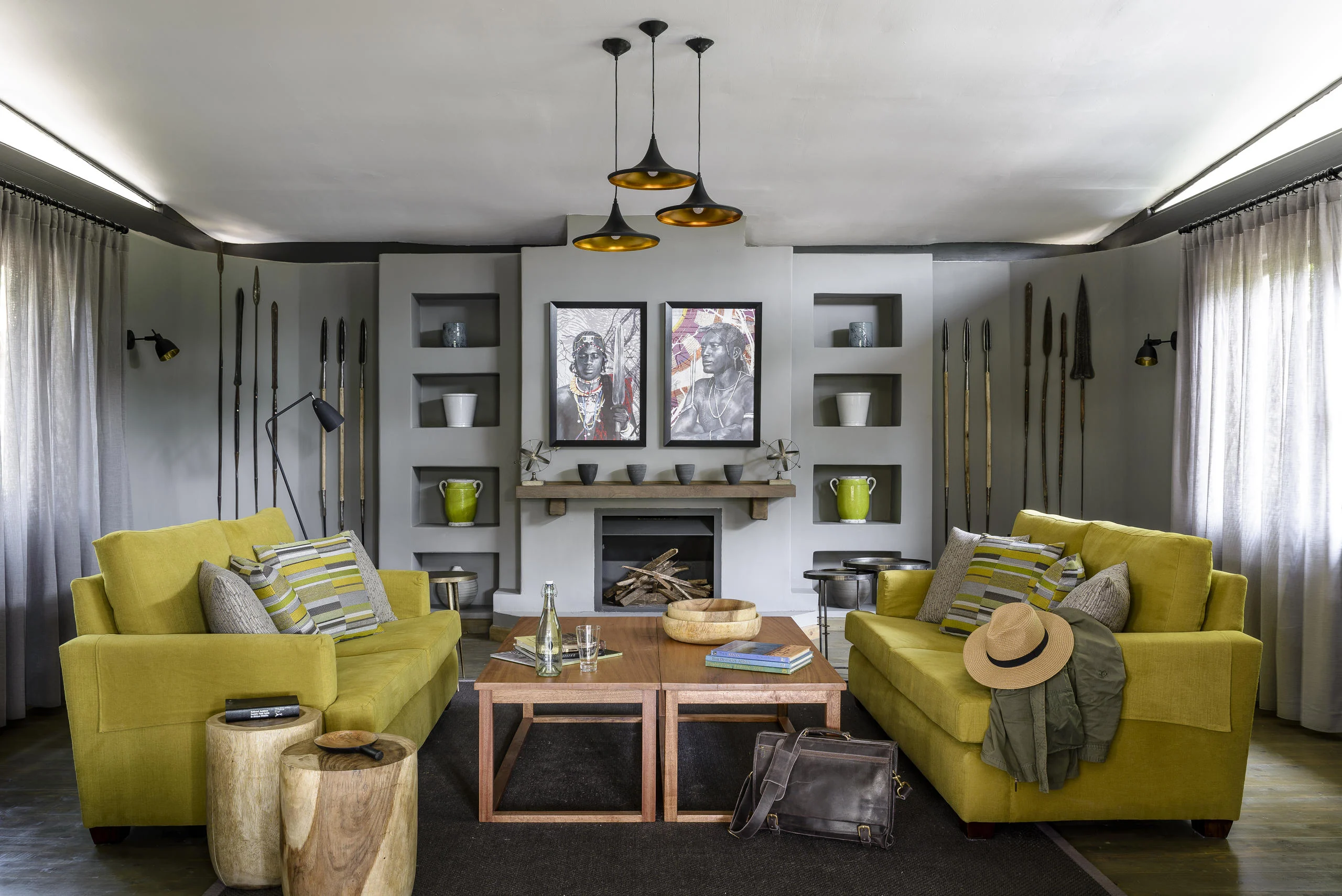 A sitting room with yellow sofas and a fireplace