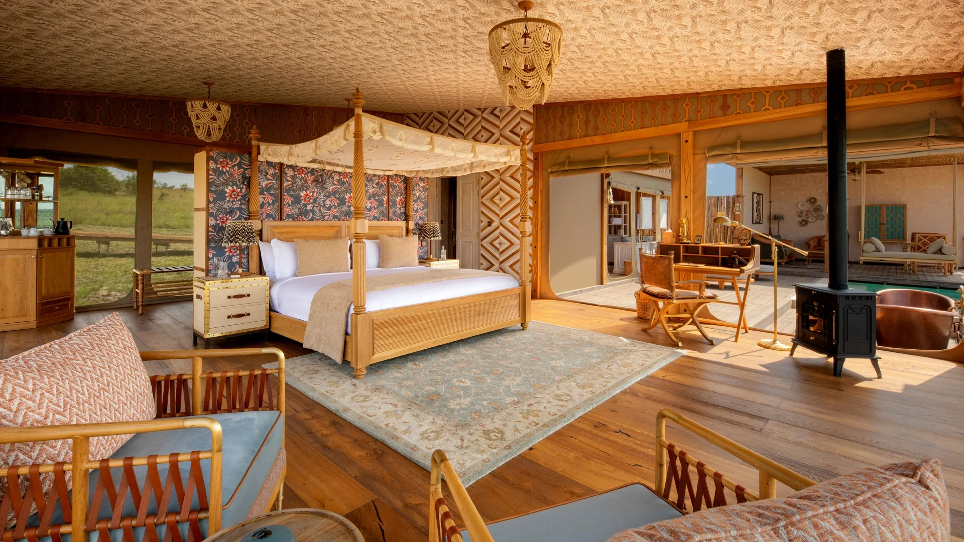 A suite with a four-poster bed and a sitting area