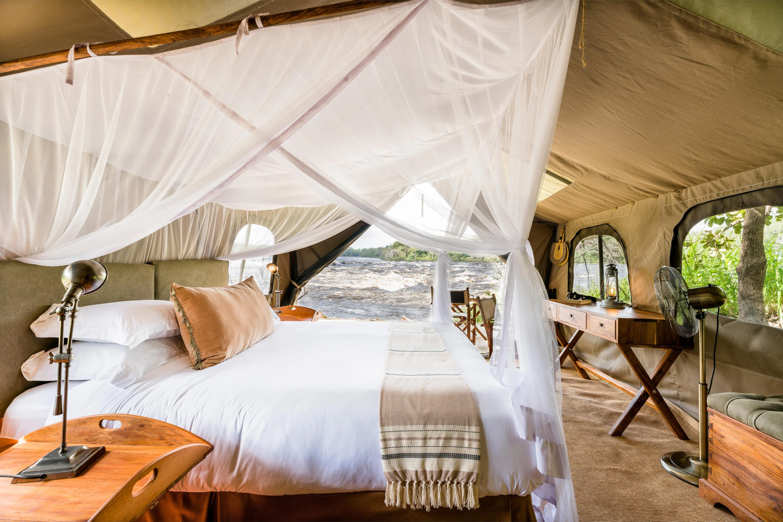 A tent bedroom with a draped bed