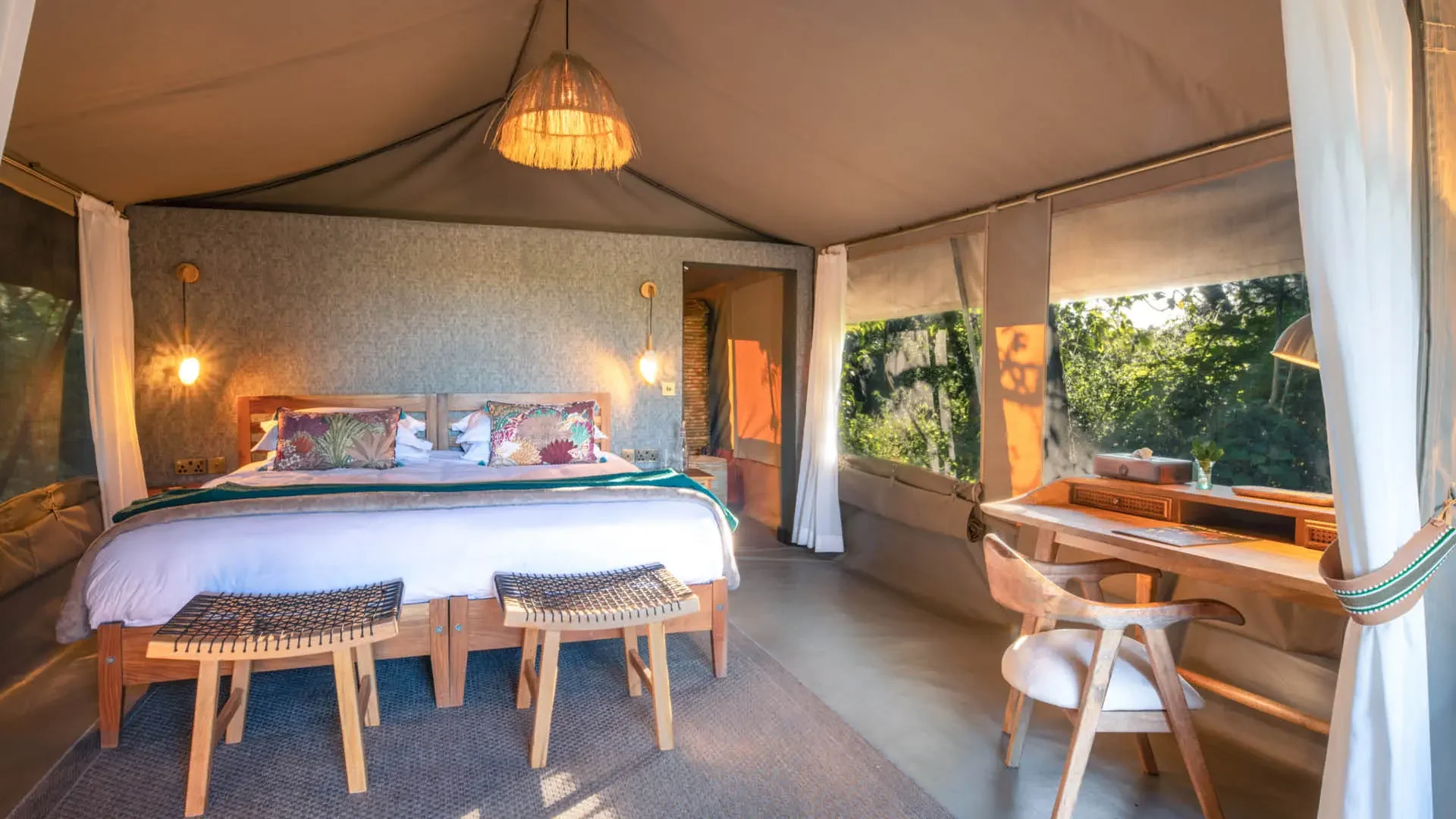 A tent bedroom looking out to the trees