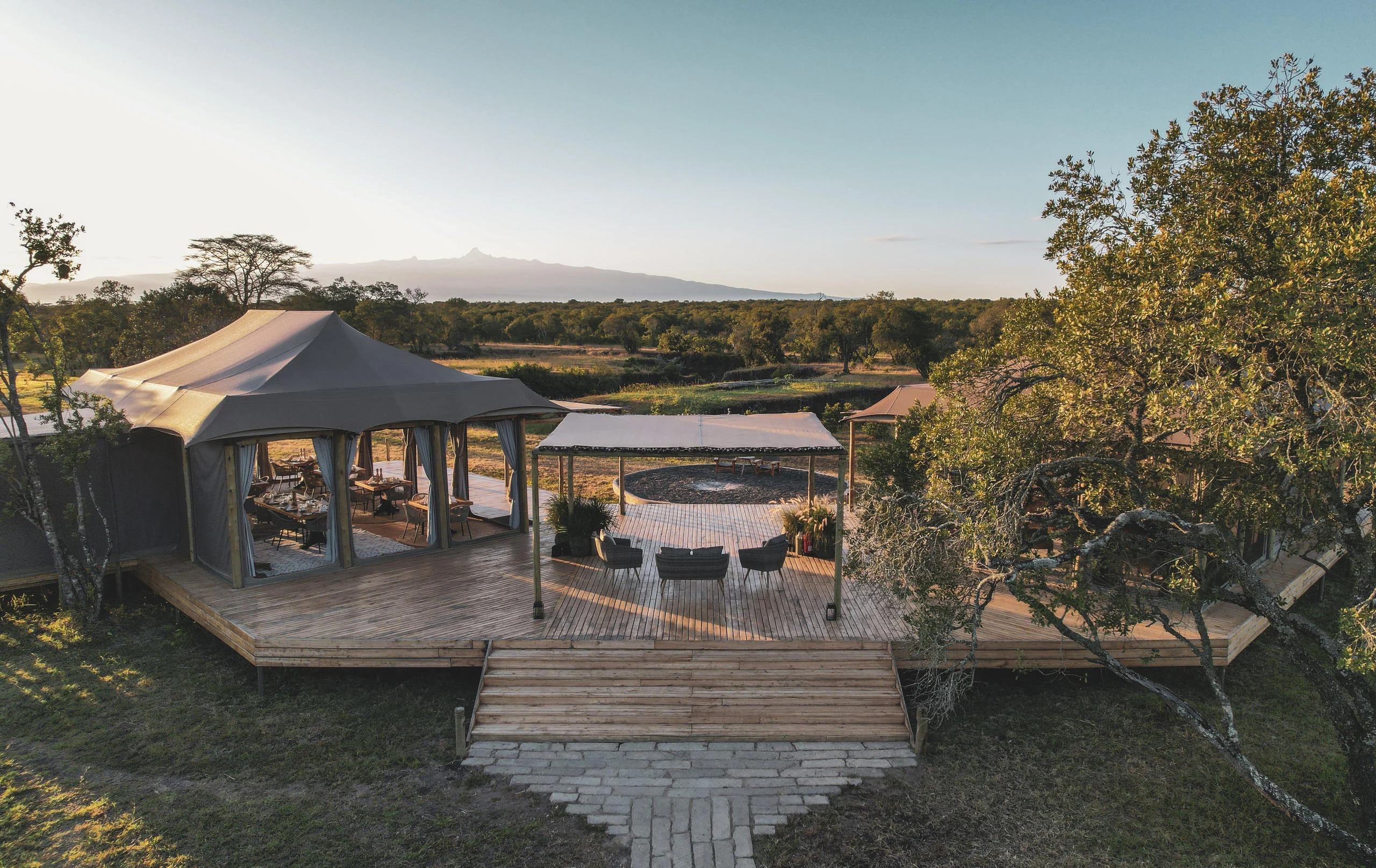 The main tent and its deck among the trees