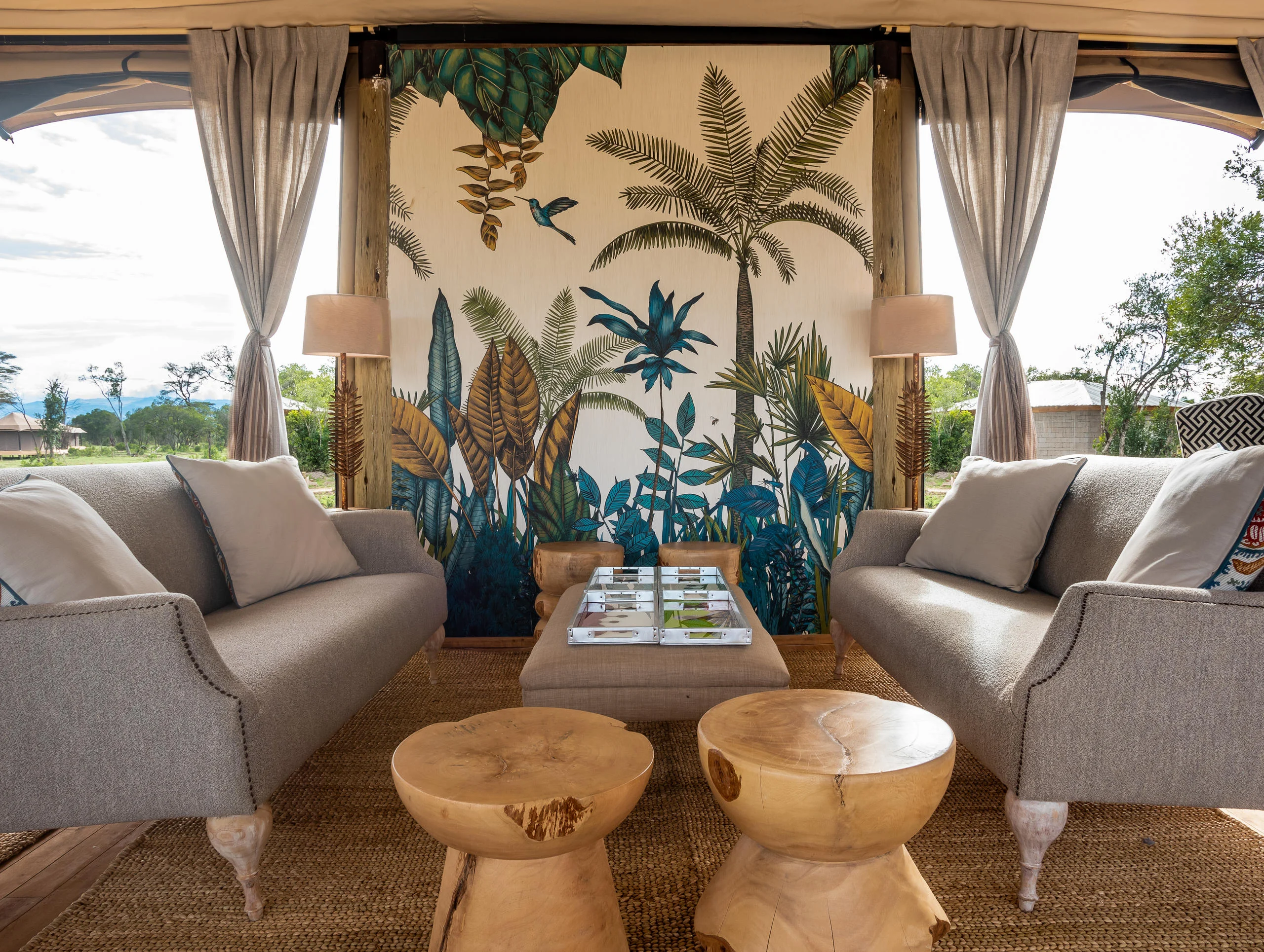 The lounge tent with sofas and a painted screen