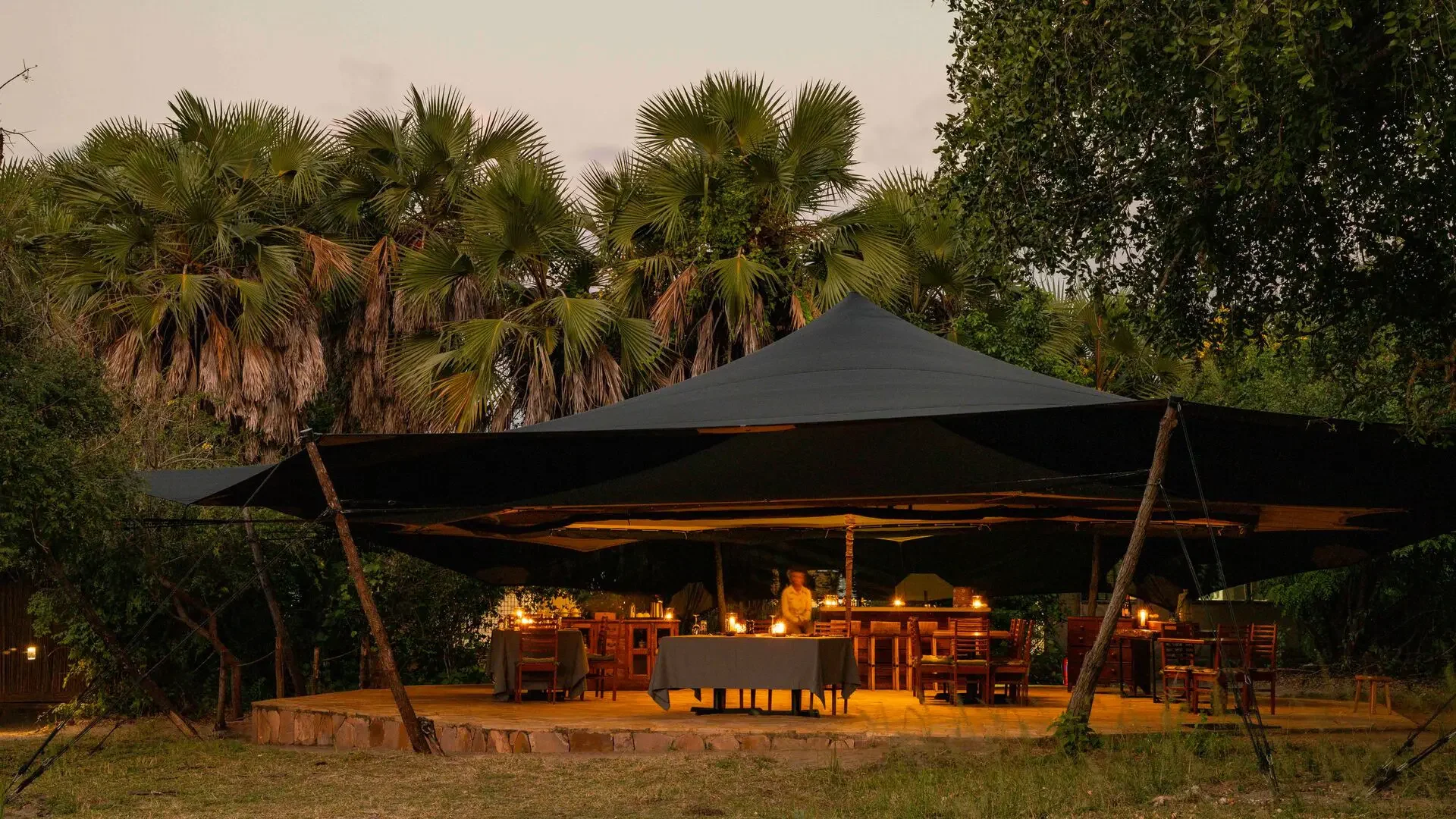 A guest tent lit in the evening