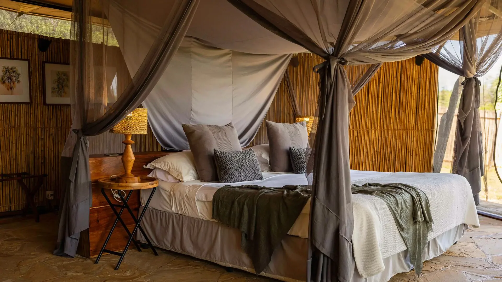 A tent bedroom with a canopied bed