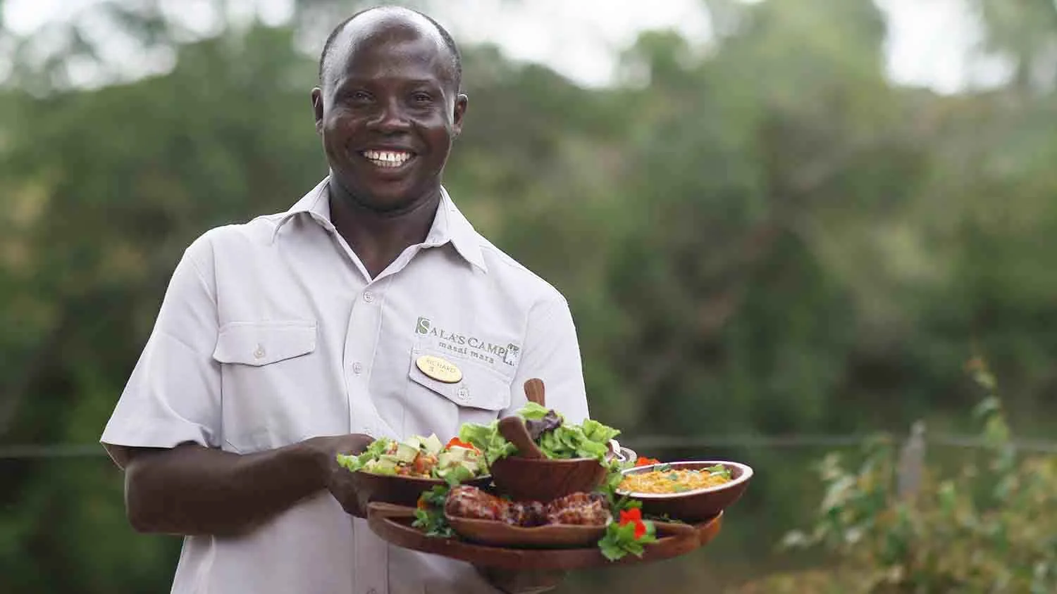 A member of staff carrying a lunch platter