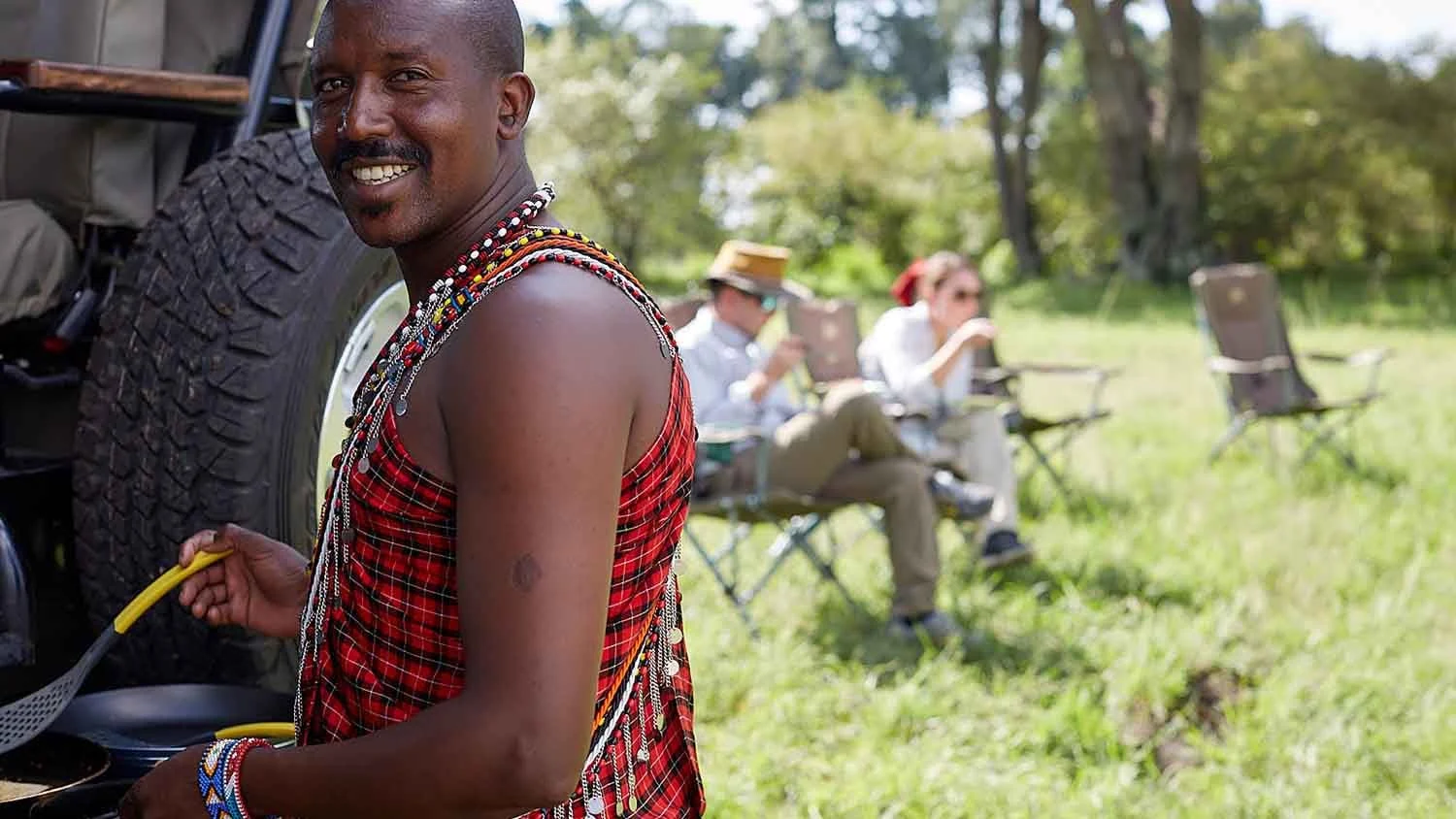 A Maasai guide cooking breakfast in the bush